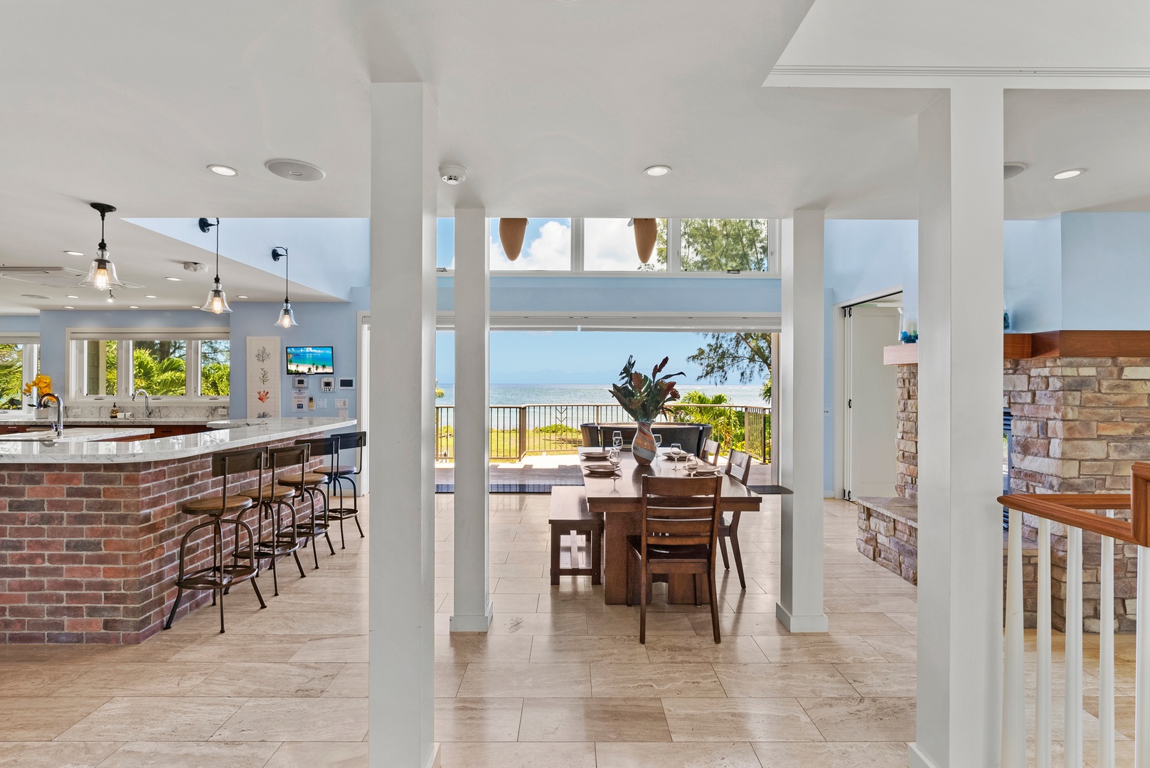 Waialua Vacation Rentals, Waialua Beachfront Getaway - Dining area with windows and hidden pocket doors that open the entire room