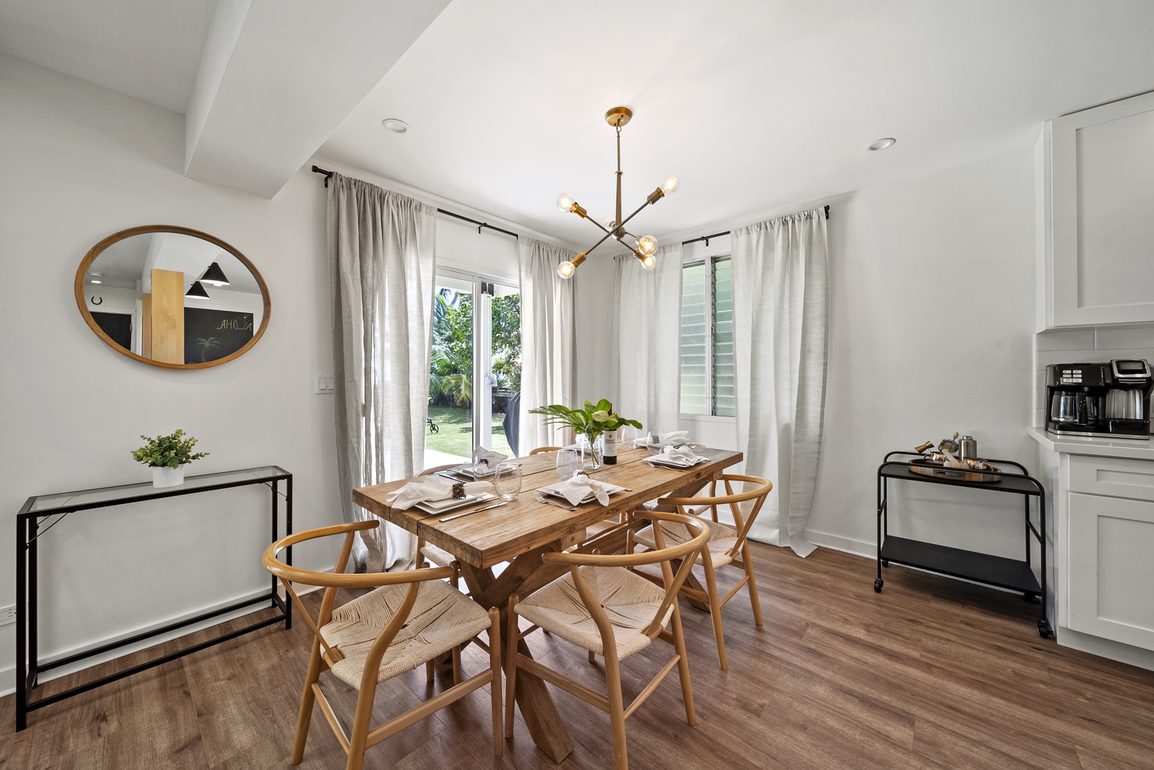 Honolulu Vacation Rentals, Honolulu Beachfront Retreat - Open-concept dining nook with stylish modern furniture, providing a sunny and intimate spot for leisurely breakfasts or game nights.