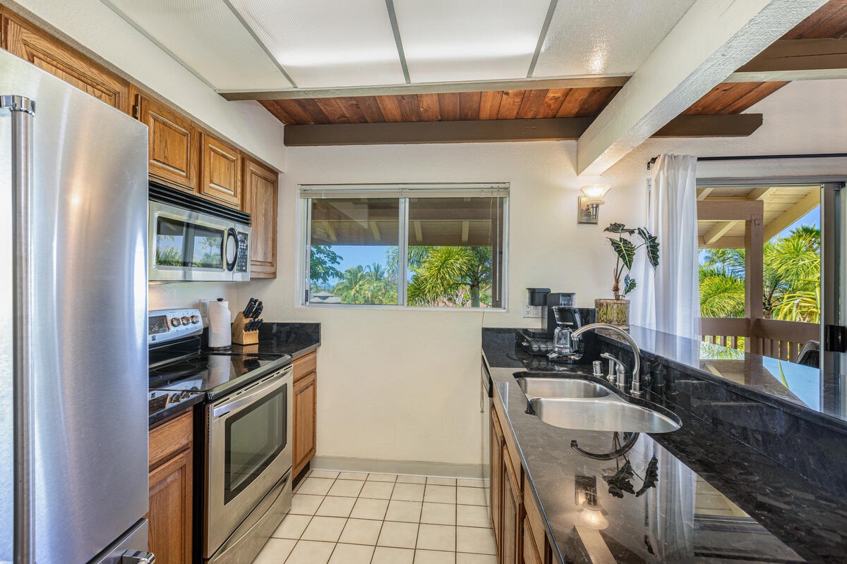 Princeville Vacation Rentals, Hale Ohana Ho'omaka - Fully equipped galley kitchen. Includes modern appliances and an efficient layout.