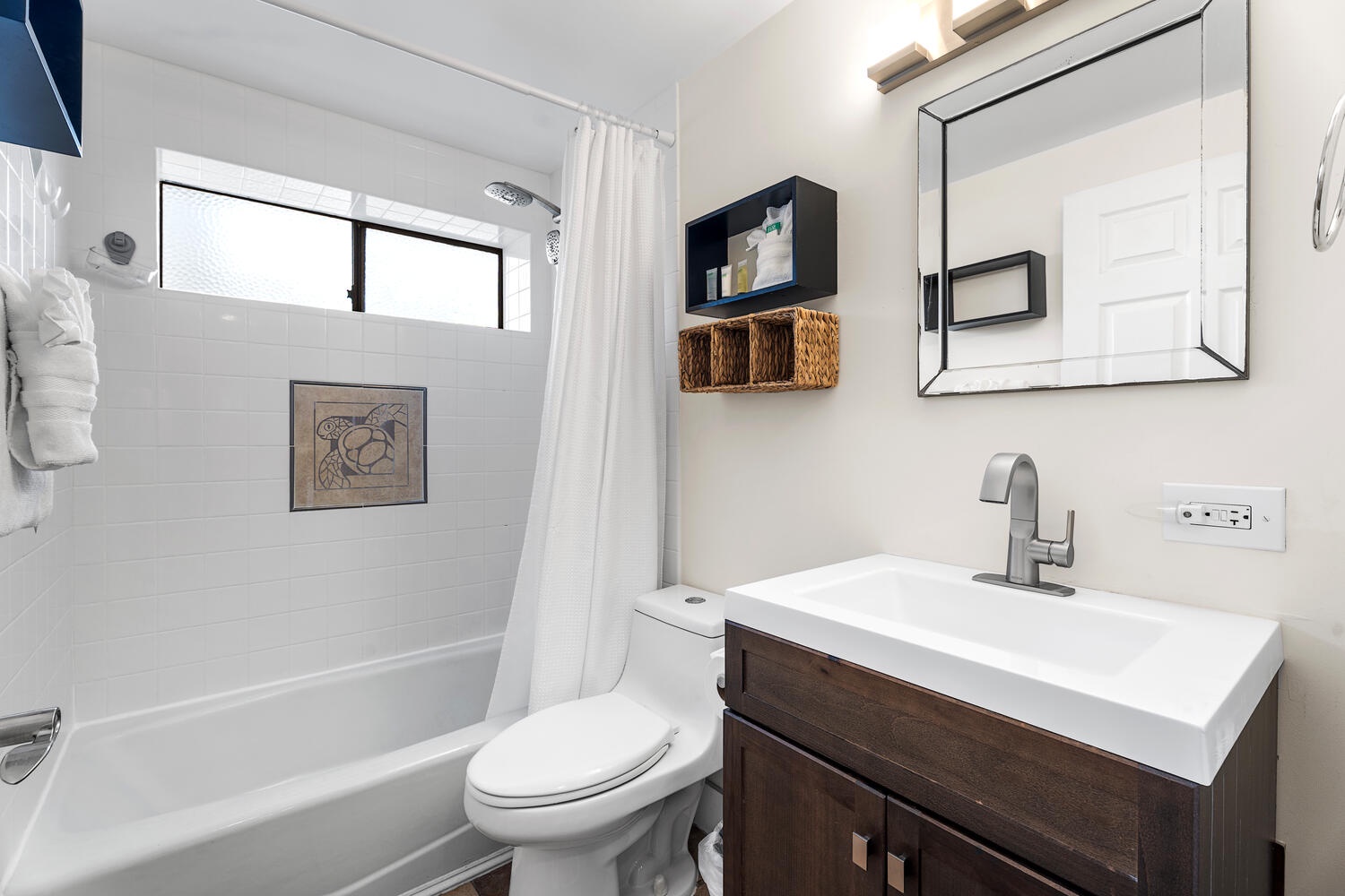 Kailua Kona Vacation Rentals, Kona Plaza 201 - Features a sleek vanity, full tub-shower combo, and thoughtful storage details for a refreshing start to each morning.