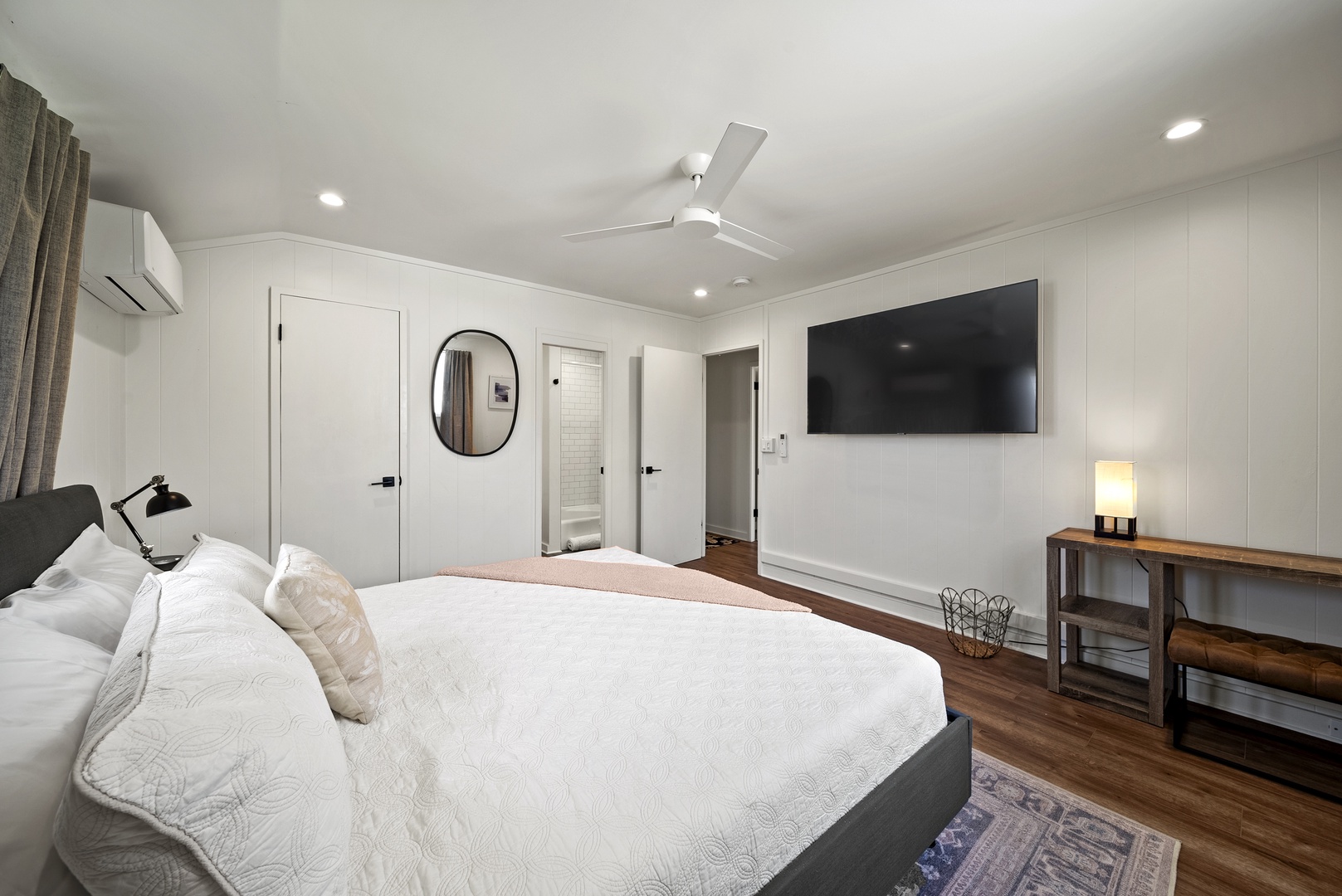 Honolulu Vacation Rentals, Honolulu Beachfront Retreat - Cozy sleeping area highlighted by neutral tones, ceiling fan, and easy flow into the living space.