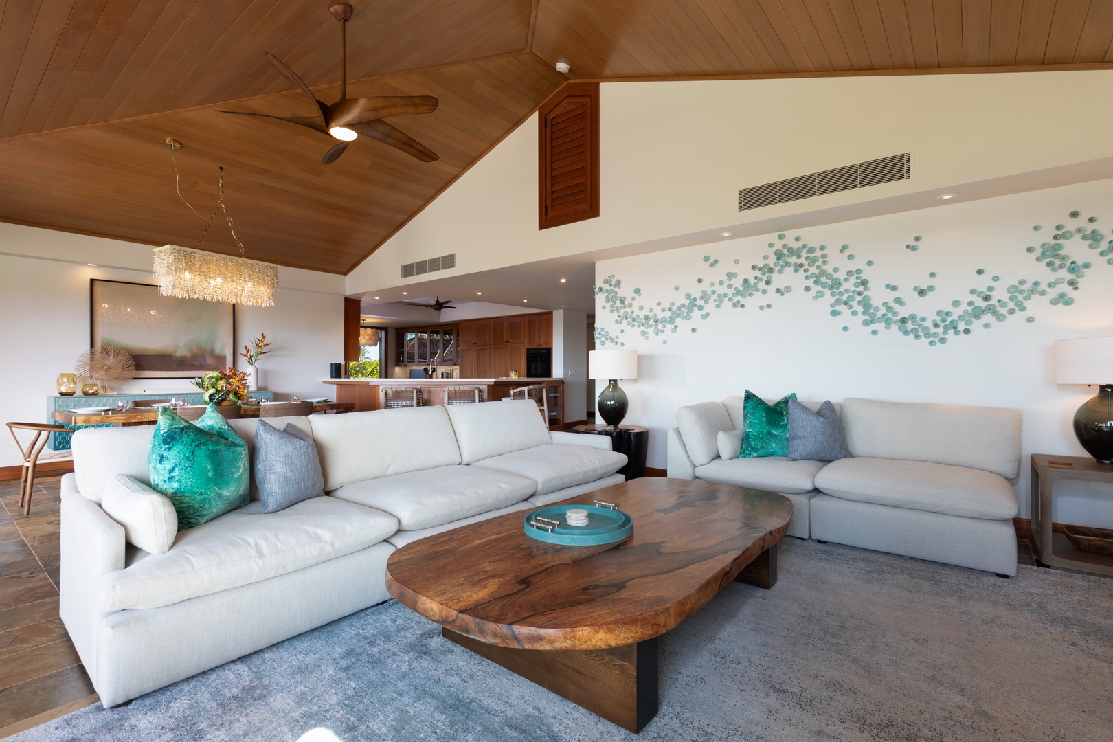 Kailua Kona Vacation Rentals, 3BD Waiulu Villa (111D) at Hualalai Resort - Cozy lounge area with plush sofas, color accents, custom artwork, within an open floor plan.