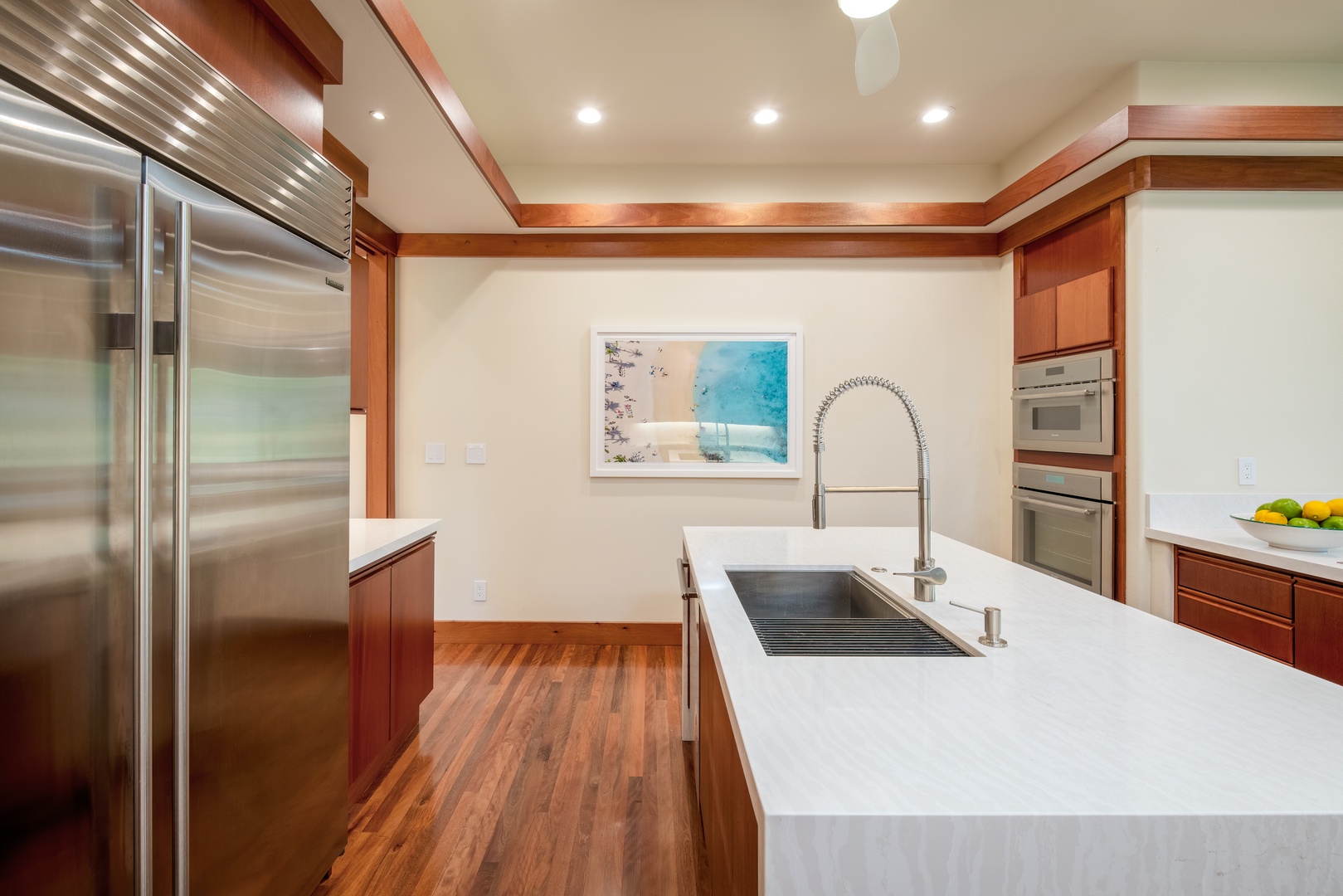 Kamuela Vacation Rentals, Champion Ridge Elegance - Open kitchen featuring a large island and abundant workspace for culinary enthusiasts.