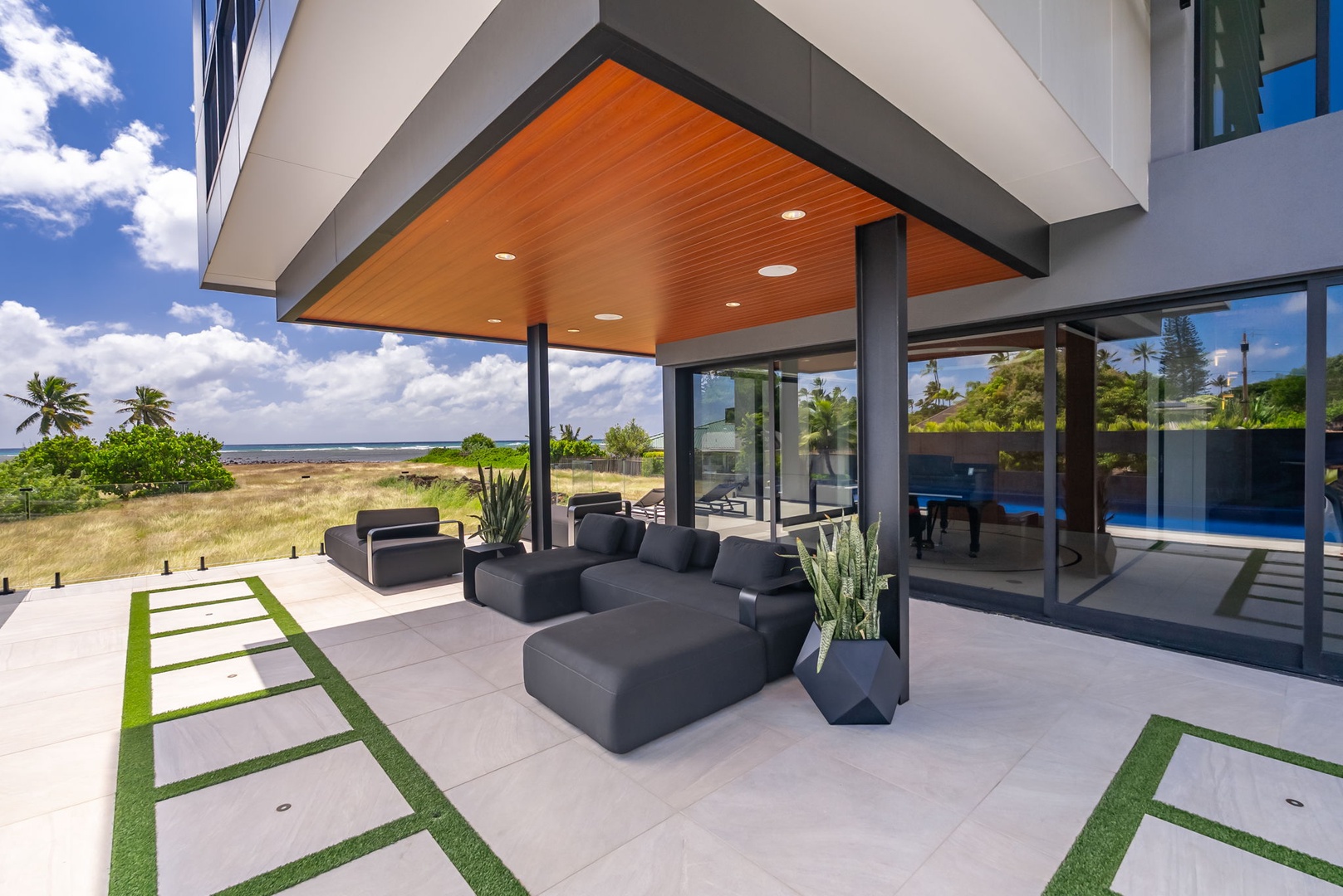 Honolulu Vacation Rentals, Ocean Villa 3 Bedroom - Modern covered lanai with relaxed seating and oceanfront setting.