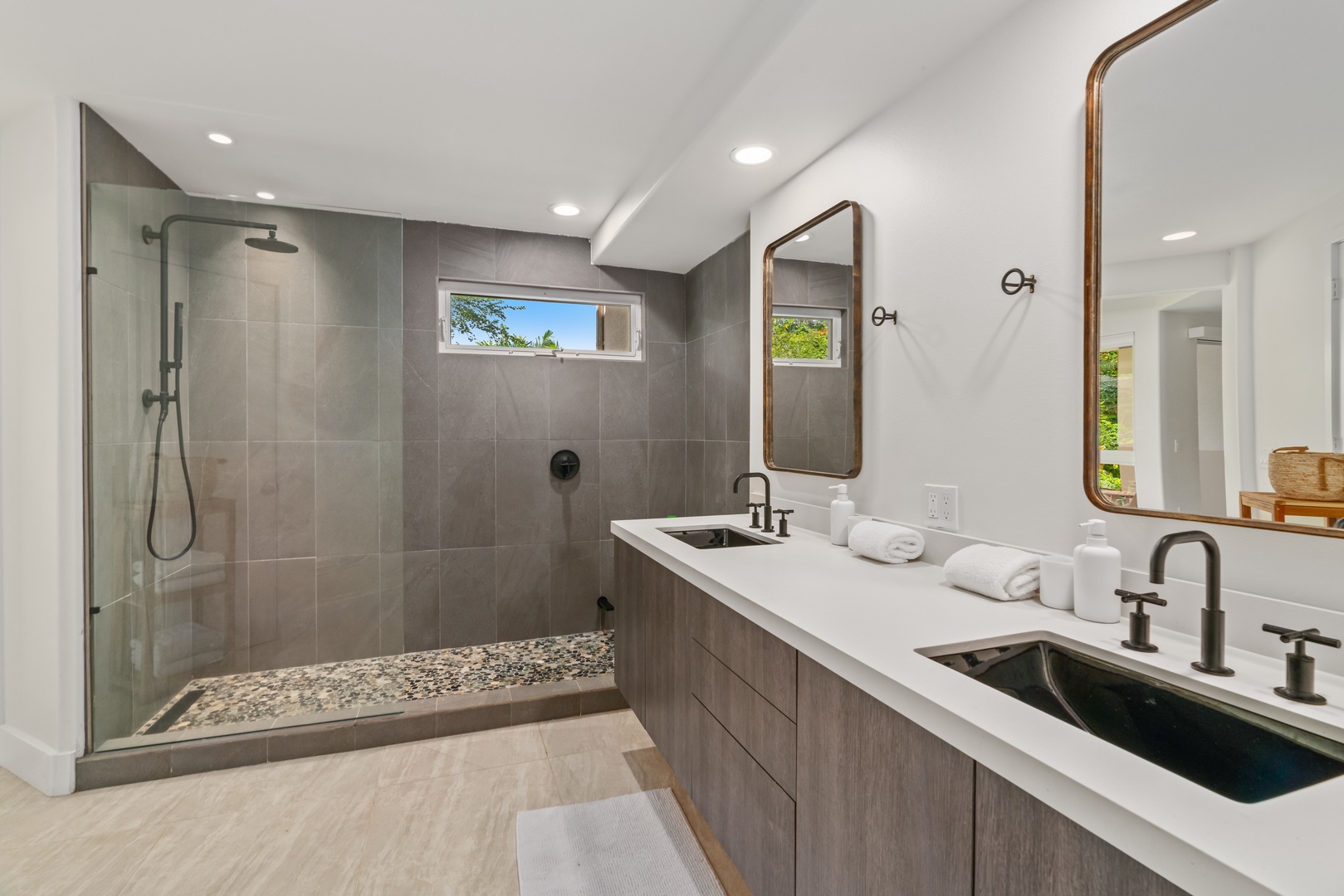Princeville Vacation Rentals, Mana Wahine - Spa-style ensuite bathroom with dual sinks and stone-accented walk-in shower.