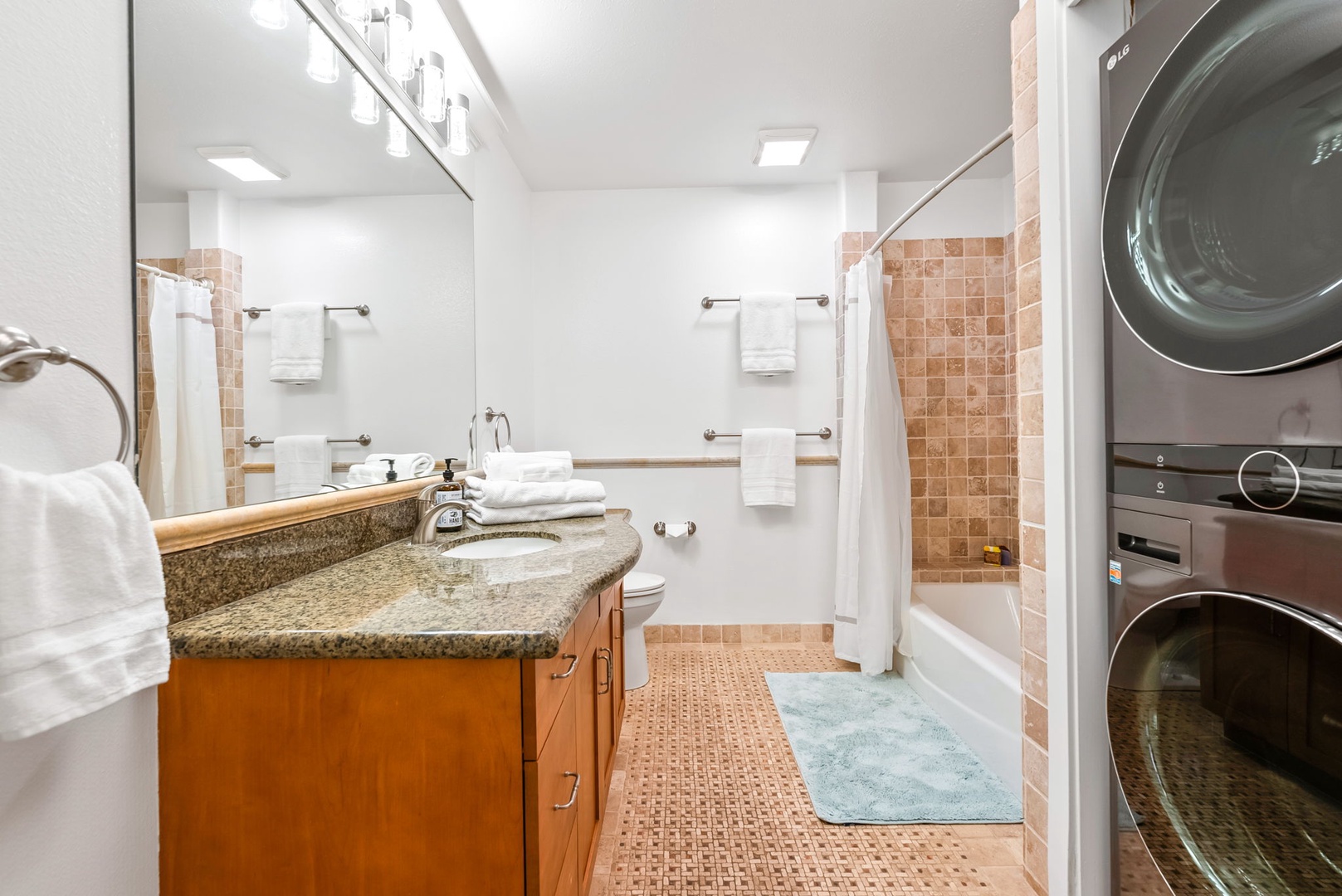 Kapolei Vacation Rentals, Kai Lani Luxury 6D - Primary bathroom with a spacious vanity, large mirror, and a shower-tub combo for a spa-like experience.