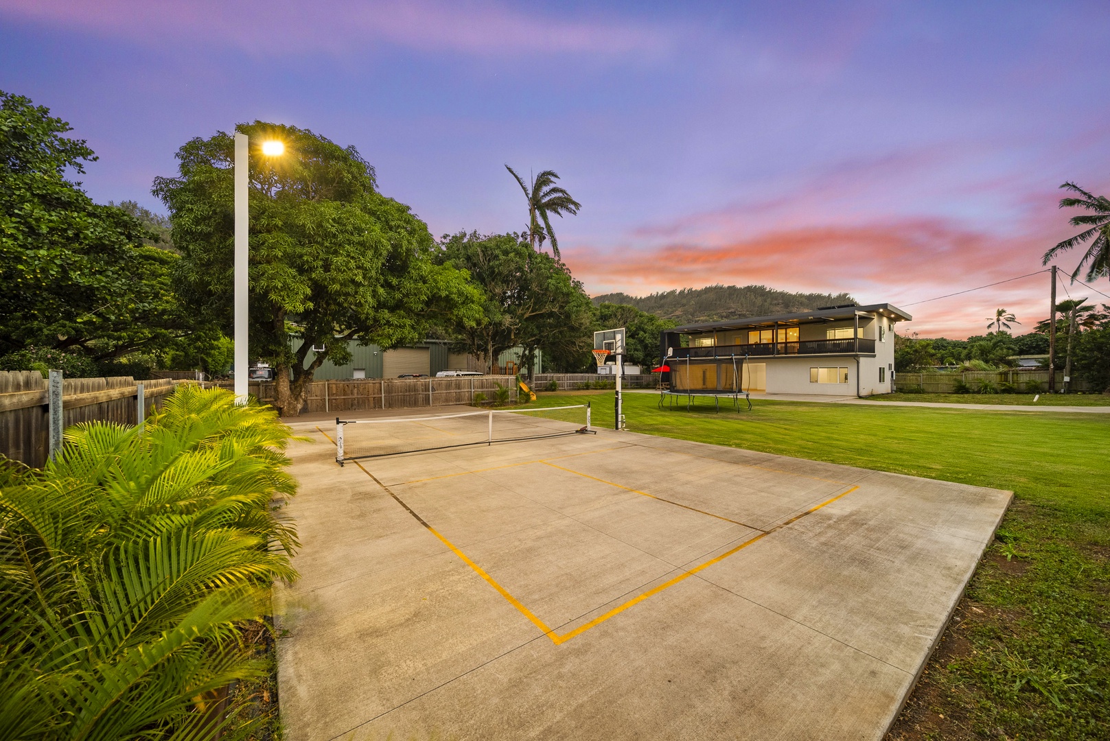 Haleiwa Vacation Rentals, Sunset Pickleball Paradise - Pickleball court surrounded by lush greenery provides a fun and energetic activity for guests to enjoy during their stay.