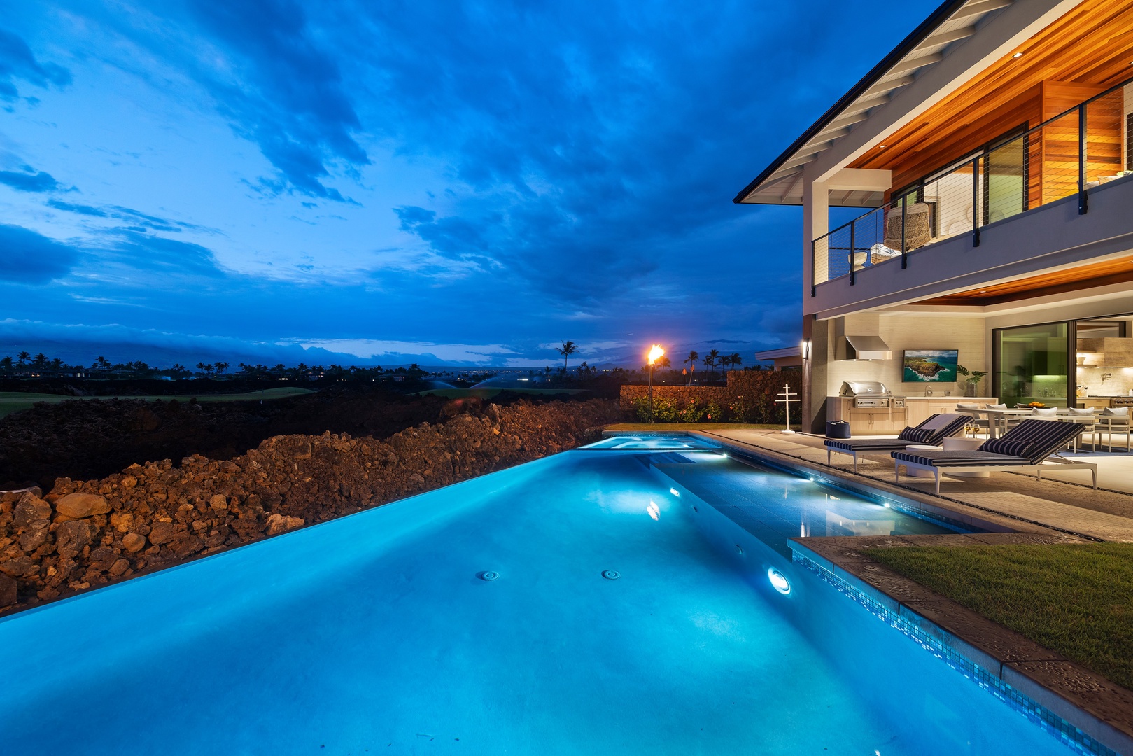 Kamuela Vacation Rentals, 6BD Mauna Lani Lux Golf Estate (6) at One Ocean - A vast evening sky stretches over the infinity pool, the home lit and waiting at its edge.