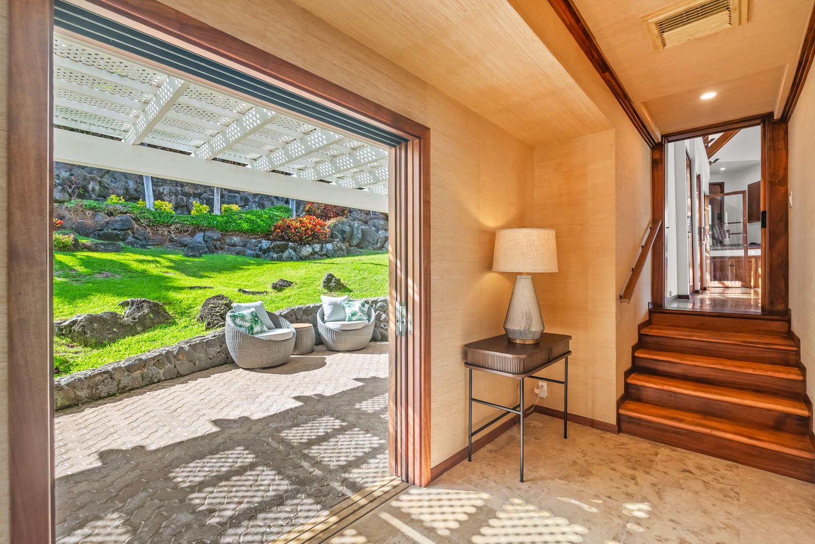 Honolulu Vacation Rentals, Black Point Ocean Villa - Private oasis where warm wooden accents frame stunning garden views through floor-to-ceiling windows.