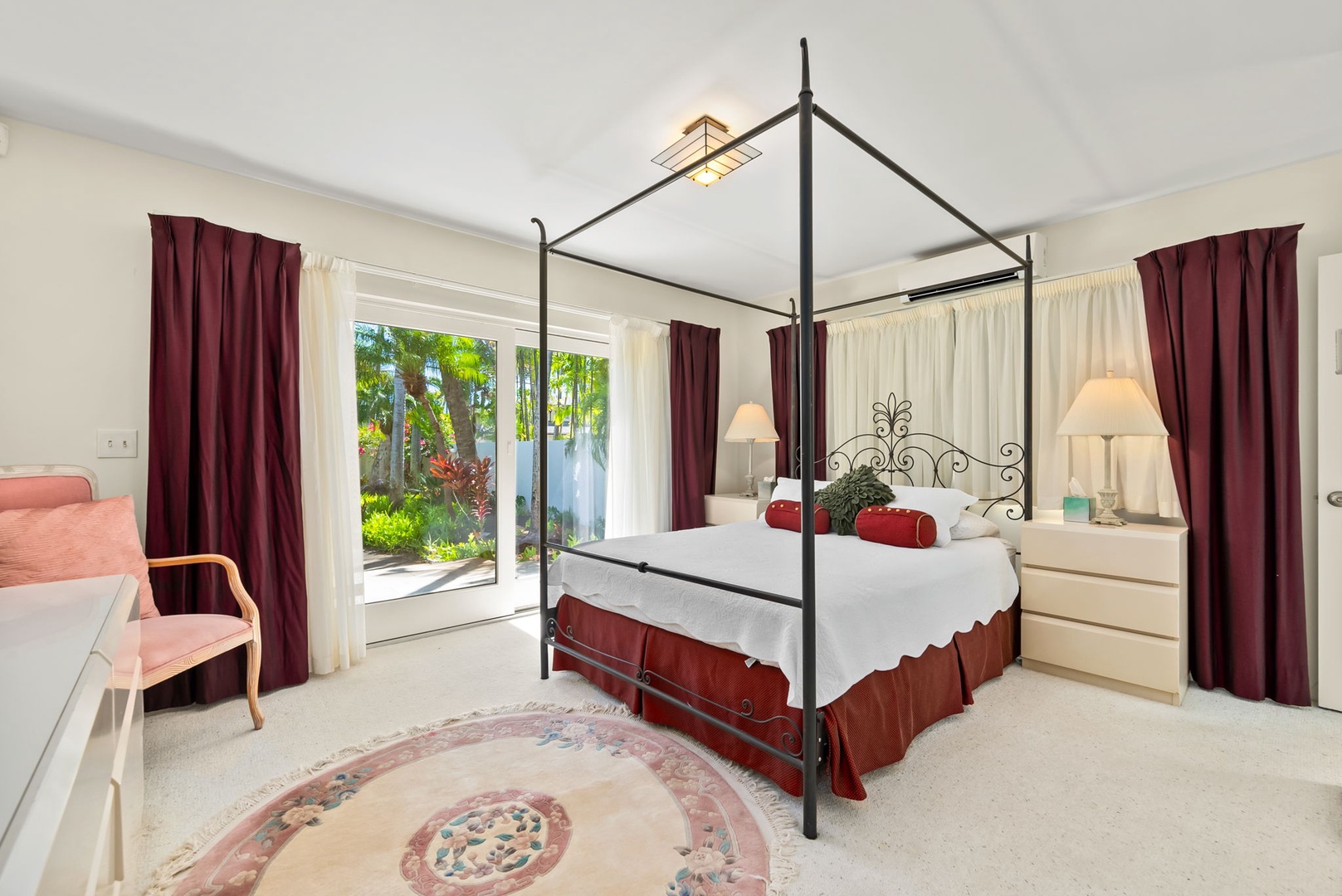 Honolulu Vacation Rentals, Kahala Oasis - Charming suite with a four-poster bed and large windows offering a beautiful view of the surrounding garden.