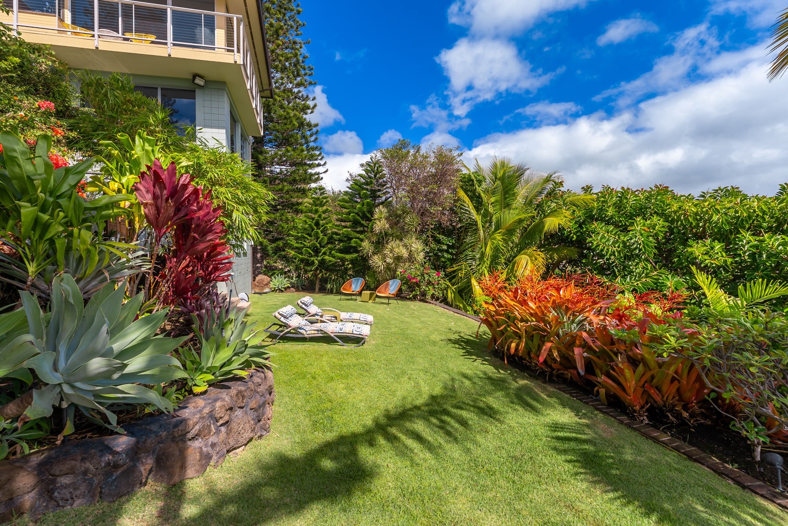 Honolulu Vacation Rentals, Kahala Hills Estate - Wander through the vibrant garden paths or enjoy a peaceful moment on the sun-drenched lawn.