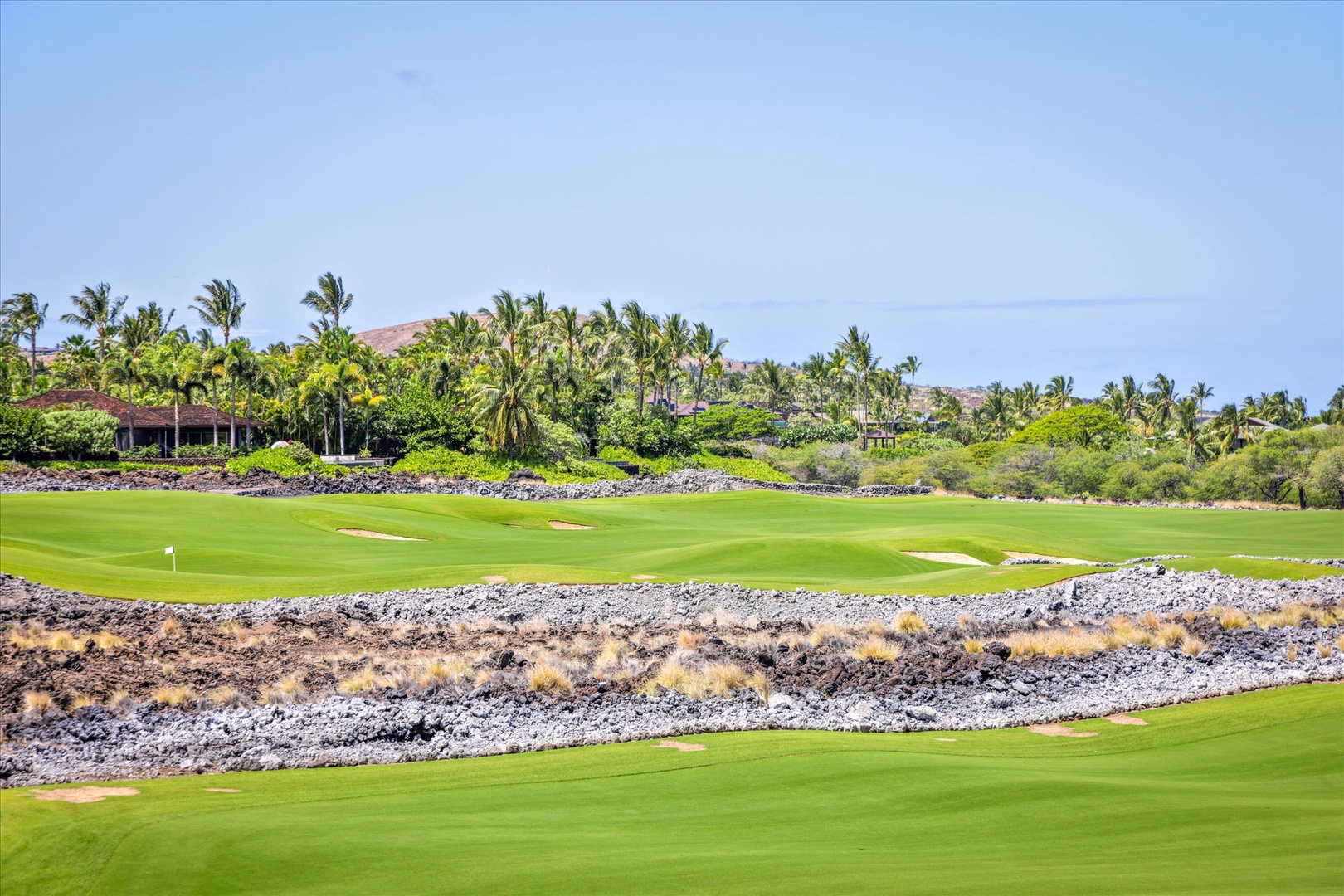 Kailua Kona Vacation Rentals, Wai'ulu Villa 115D - Signature holes at Hualalai Golf Course surrounded by lava rock and tropical beauty—pure Big Island prestige.
