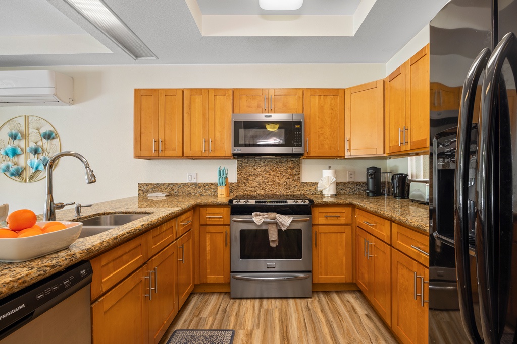 Your fully equipped kitchen features warm wood cabinets, granite countertops, and stainless steel appliances—perfect for preparing memorable meals during your stay.