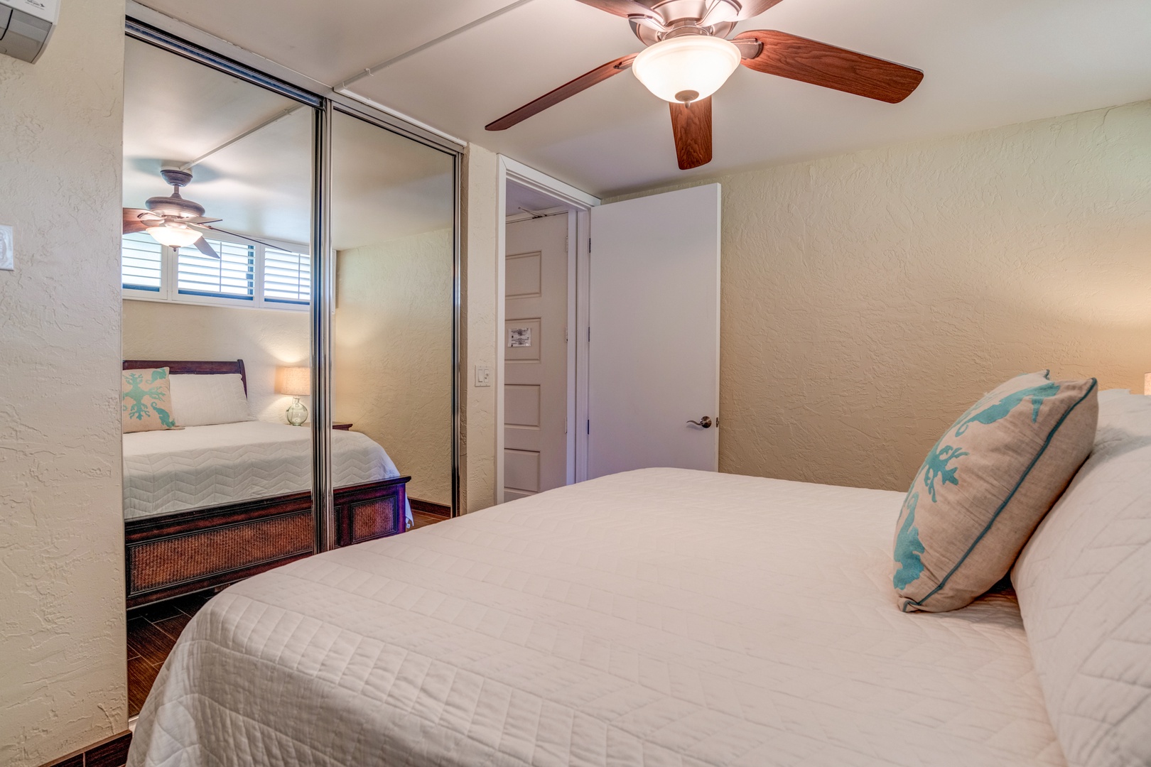 Lahaina Vacation Rentals, Papakea B-105 - The bedroom offers spacious storage with mirrored closet doors, creating a bright and airy atmosphere