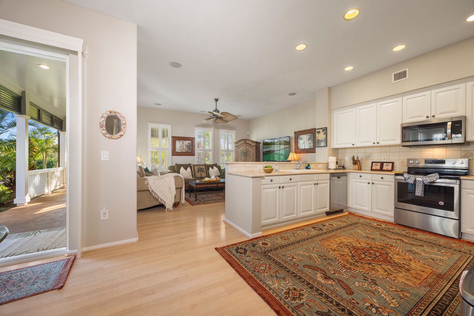 Step into your open-concept haven where the fully-equipped kitchen flows seamlessly into the cozy living room, creating perfect spaces for cooking and relaxing together.