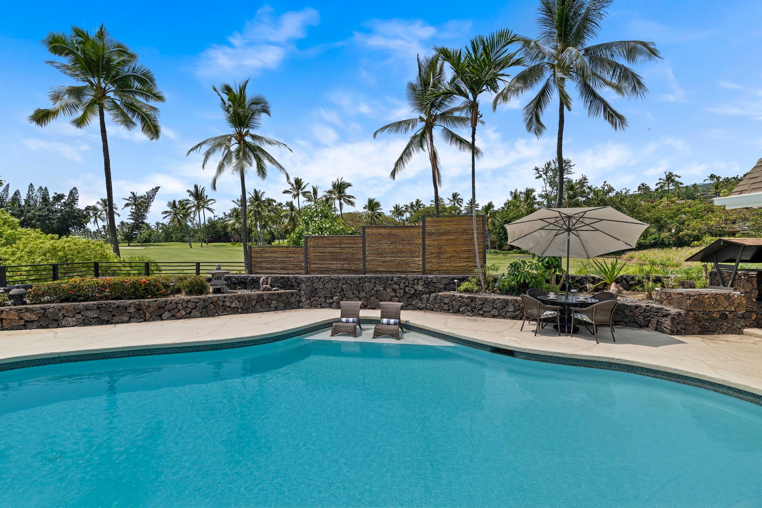 Kailua Kona Vacation Rentals, Manukai Hale - Palms lean over the pool where the deck meets the golf course