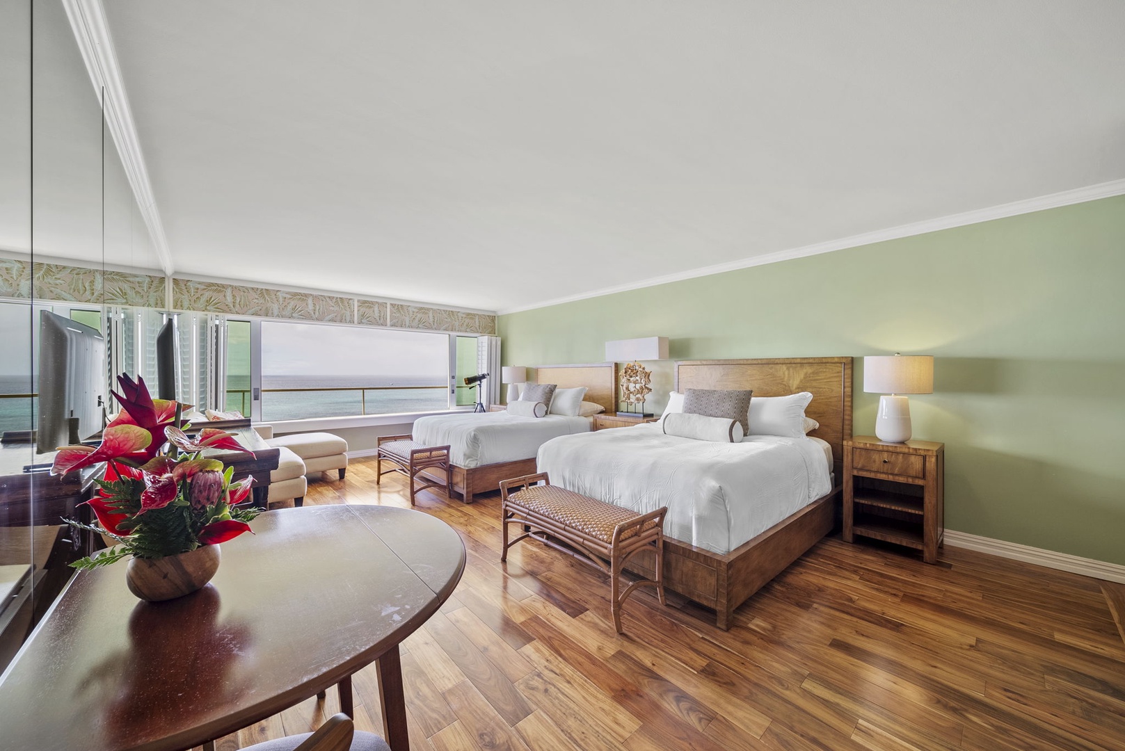 Honolulu Vacation Rentals, Colony Surf #1403 - Spacious bedroom with hardwood floors, cozy seating, and serene decor for ultimate relaxation.