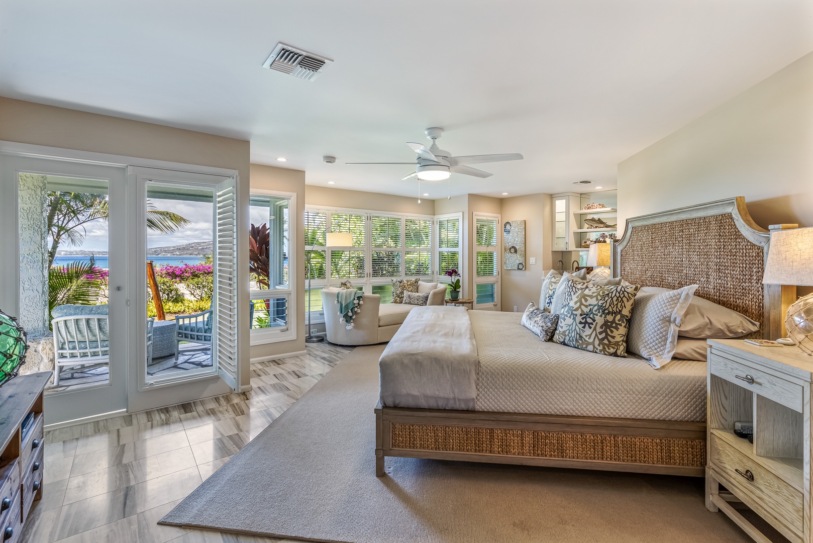 Honolulu Vacation Rentals, Hale Ola - Luxurious Primary with a king-sized bed accompanied by a cozy sitting area, a convenient wet bar complete with a mini-fridge and coffee maker
