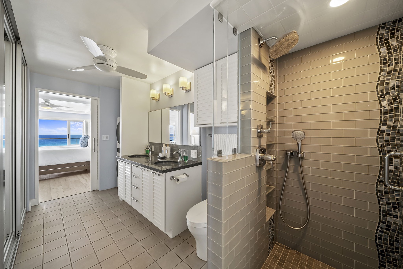 Honolulu Vacation Rentals, Kaimana Tides at Colony Surf - Your spacious bathroom features a luxurious walk-in shower with mosaic accents and modern fixtures for ultimate relaxation.