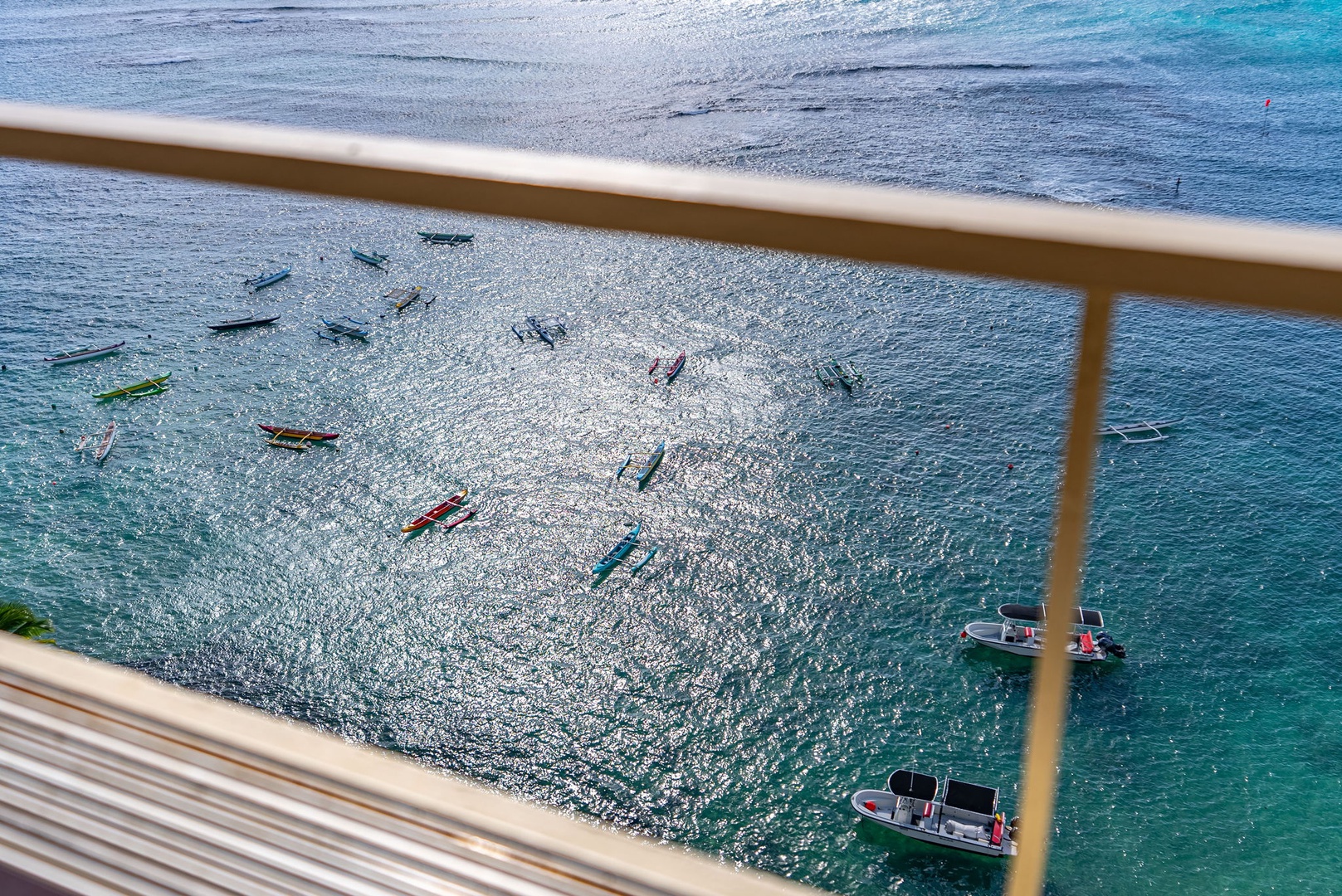 Honolulu Vacation Rentals, Hale Kaimana - A stunning view of crystal-clear waters with colorful kayaks and boats floating below.