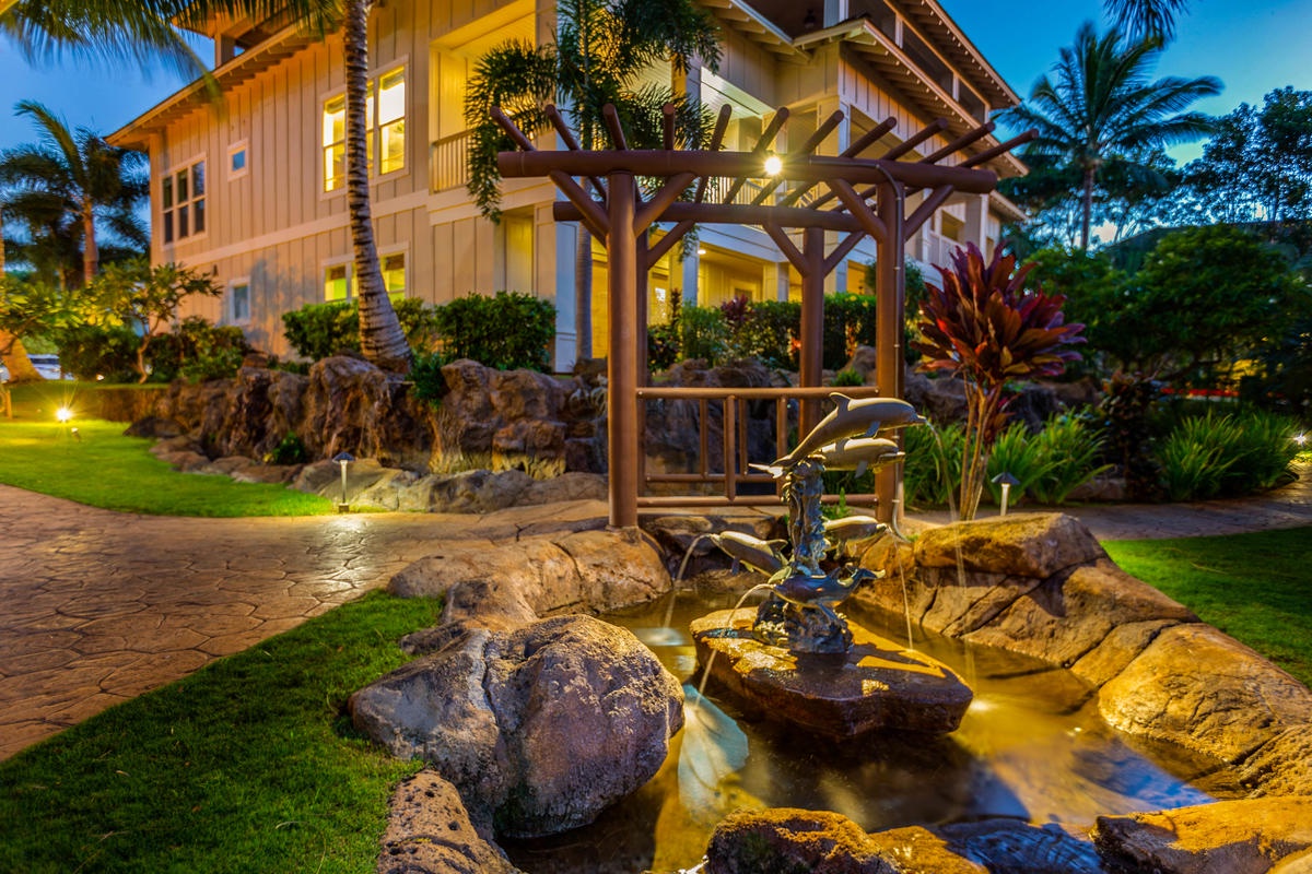 Koloa Vacation Rentals, Villas at Poipu Kai B111 - Beautifully lit resort grounds with tranquil water features, perfect for a peaceful evening walk.