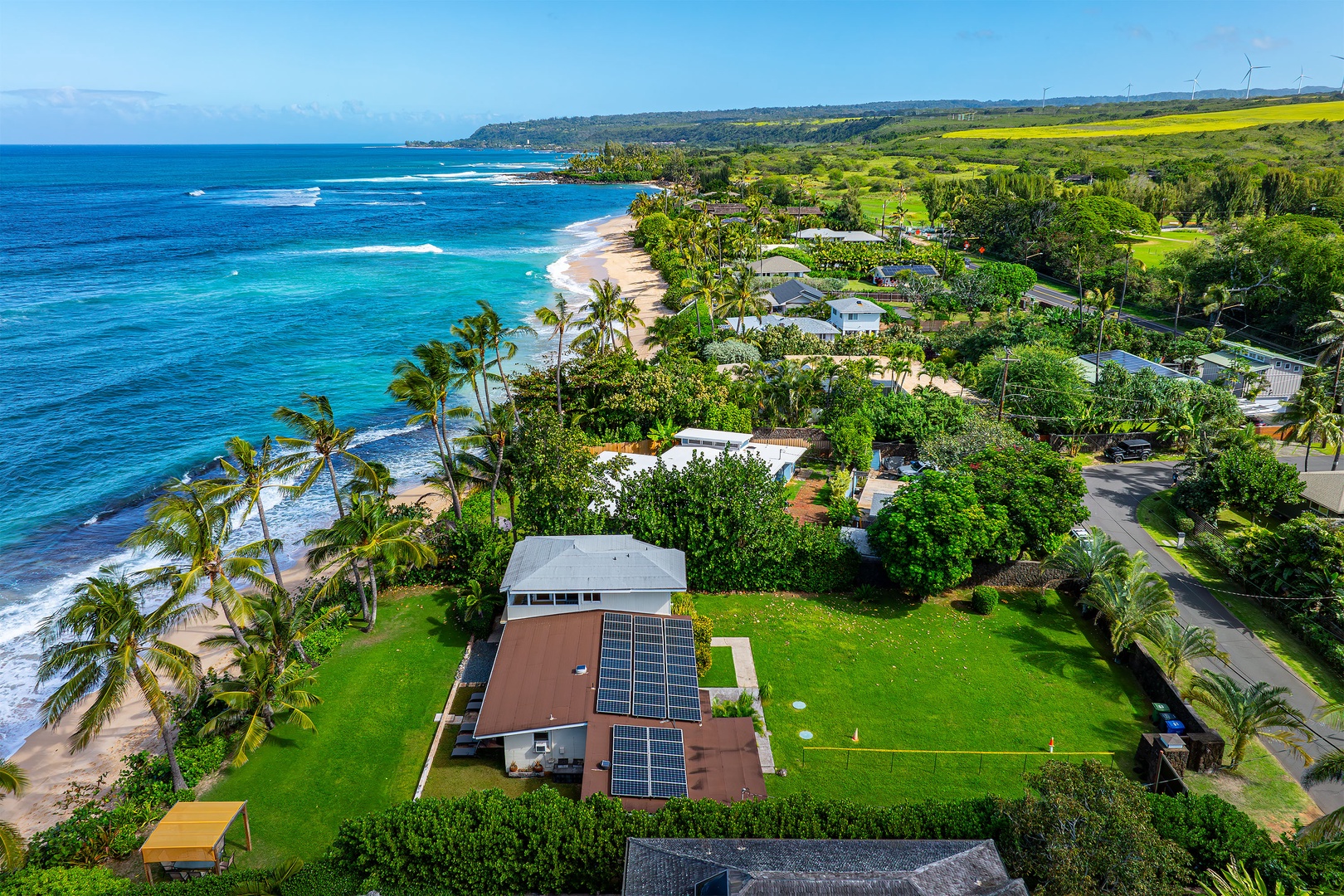 Haleiwa Vacation Rentals, North Shore Beachfront Resort - Aerial view of a tropical property surrounded by greenery.