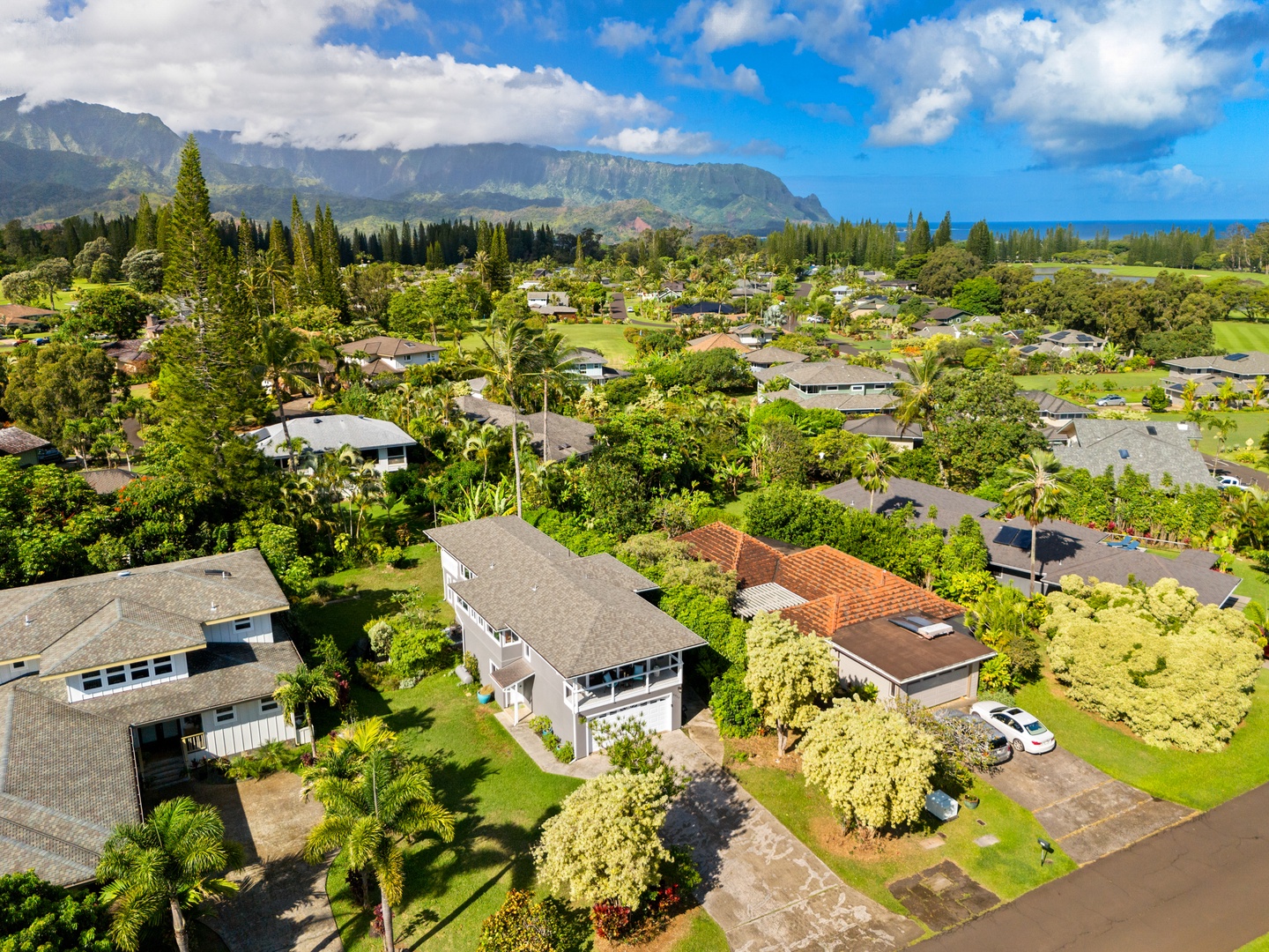 Princeville Vacation Rentals, Ola Hou - Main House - Tropical greenery and open space create a serene escape for guests.