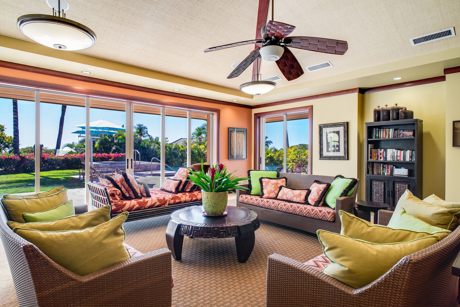 Kamuela Vacation Rentals, 3BD Wai'ula'ula Villa (312) at Mauna Kea Resort - Spacious shared living area with tropical furnishings and panoramic windows for natural light and garden views.