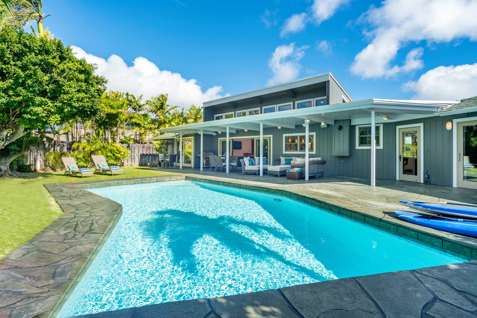 Honolulu Vacation Rentals, Hale Niuiki - Discover your escape haven, complete with a secluded backyard, pool, hammock, lounge areas, and BBQ setup.