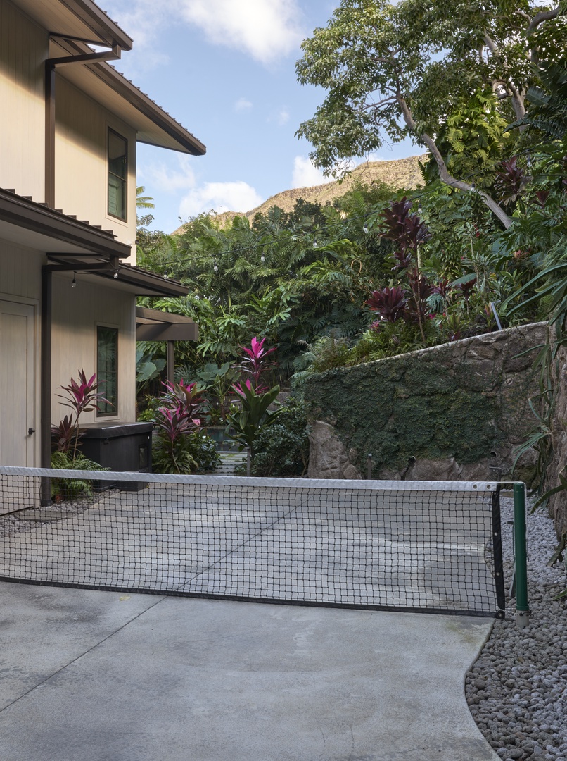 Honolulu Vacation Rentals, Diamond Head Hillside Estate** - Enjoy a friendly match on the property's unofficial pickleball court, surrounded by tropical gardens and the relaxed atmosphere of island living.
