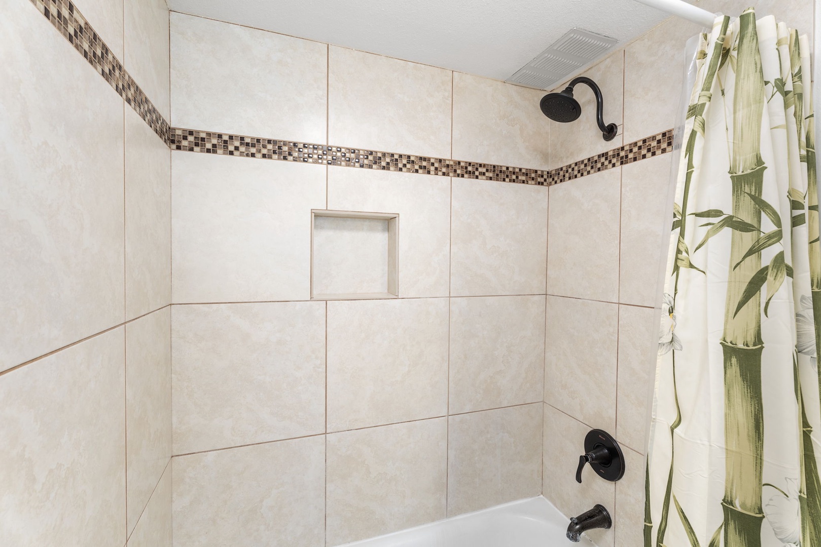 Kailua Kona Vacation Rentals, Sea Village 4213 - Tiled shower/tub combo in primary ensuite—perfect for rinsing off after beach days or adventures on the coast.