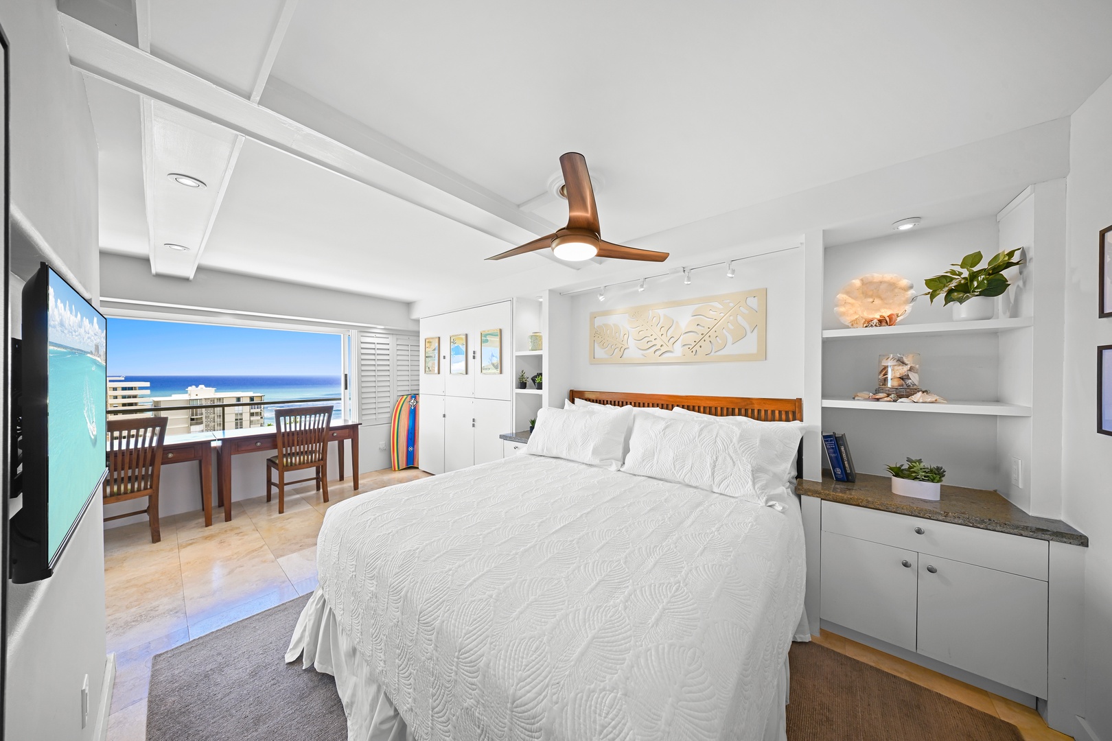 Honolulu Vacation Rentals, Kaimana Shores Getaway - The peaceful primary bedroom features a comfortable Queen bed, coastal décor, and partial ocean views.