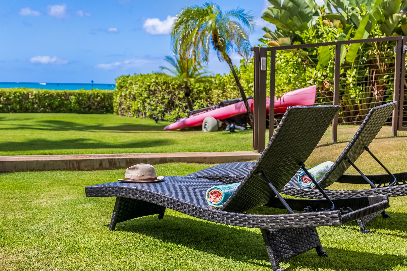 Honolulu Vacation Rentals, Nanea Kai Villa - Outdoor chaise loungers on the lawn, perfect for sun bathing.