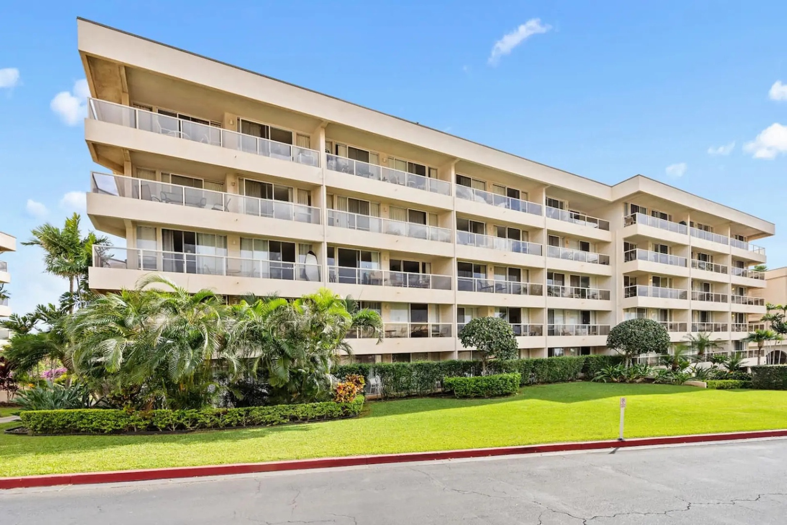 Kihei Vacation Rentals, Maui Banyan H306 - Palms and clipped hedges frame the walk up to the building each time you come and go.
