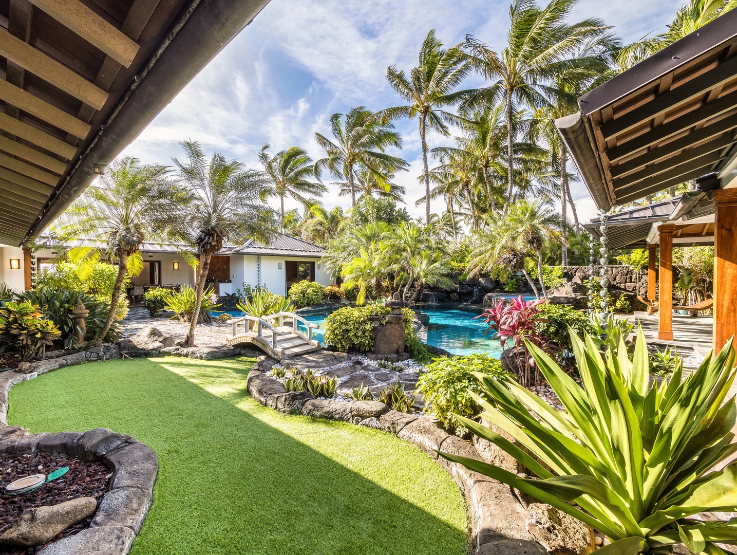 Kailua Vacation Rentals, Castle Point Estate - Lush landscaping and lava rock accents frame the tropical pool and garden pathways.
