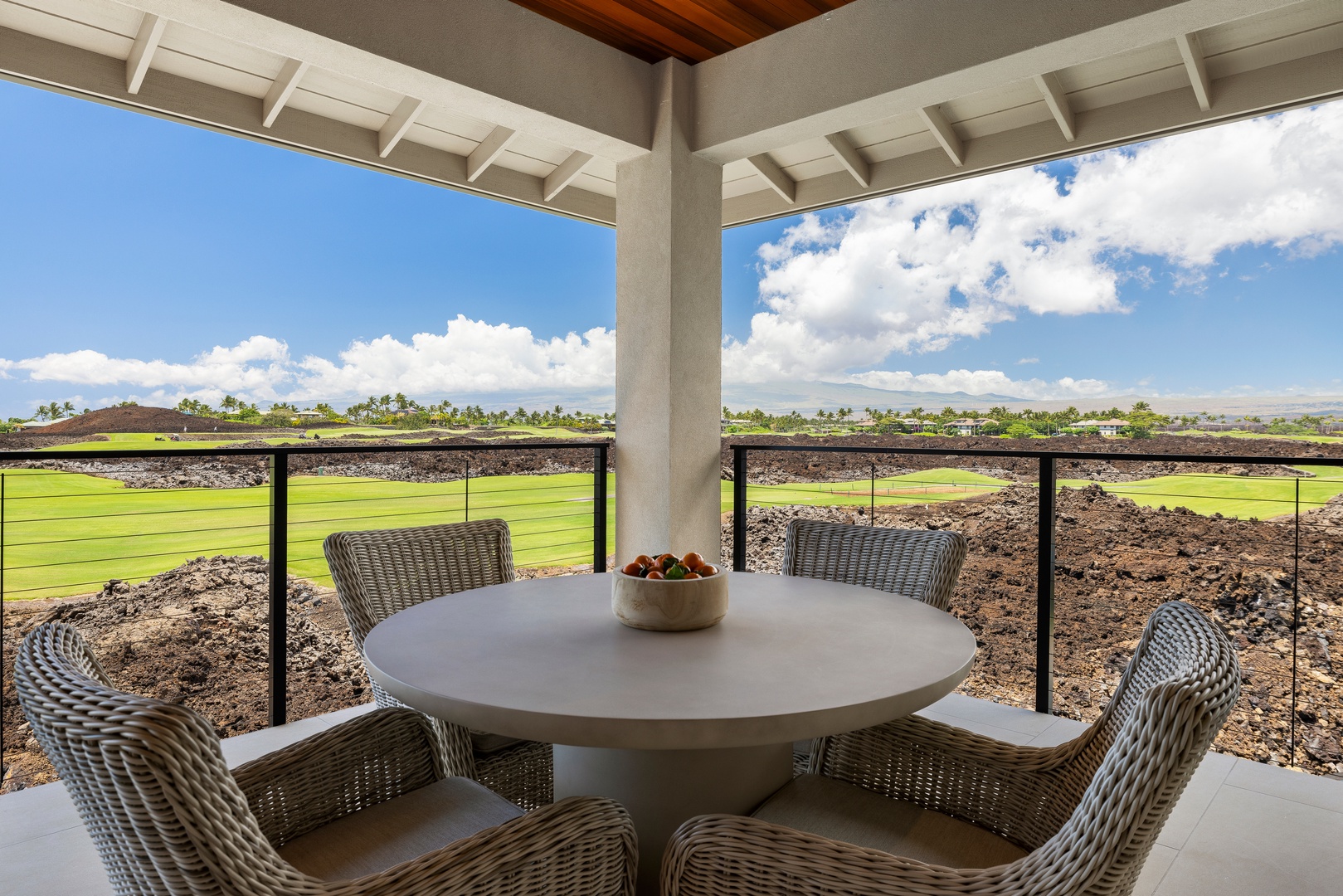 Kamuela Vacation Rentals, 6BD Mauna Lani Lux Golf Estate (5) at One Ocean - A cafe table on the lanai, the fairway wrapping around it.