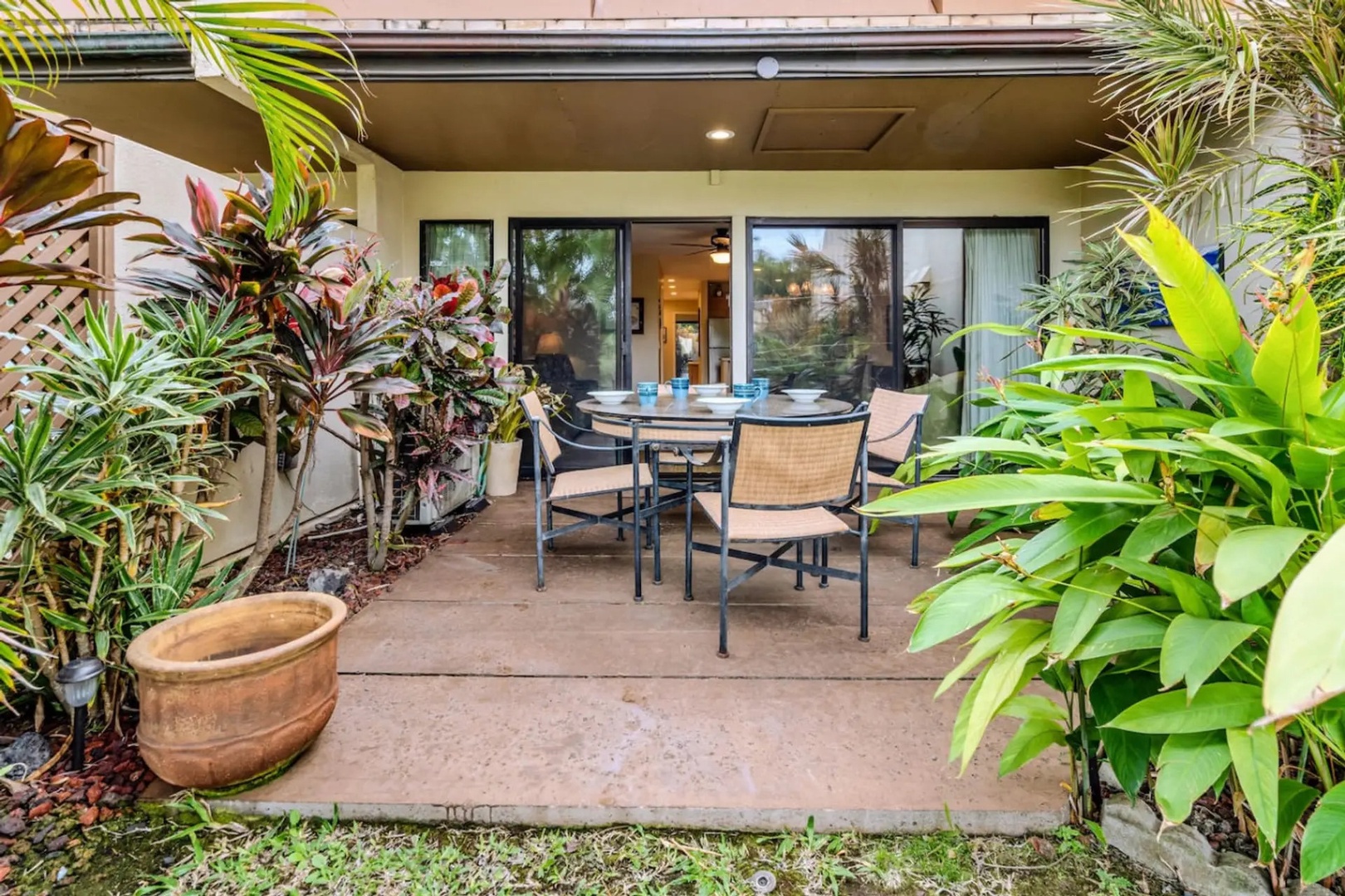 Kihei Vacation Rentals, Maui Kamaole E103 - Step through the open sliders to a lanai table already set for the next meal.