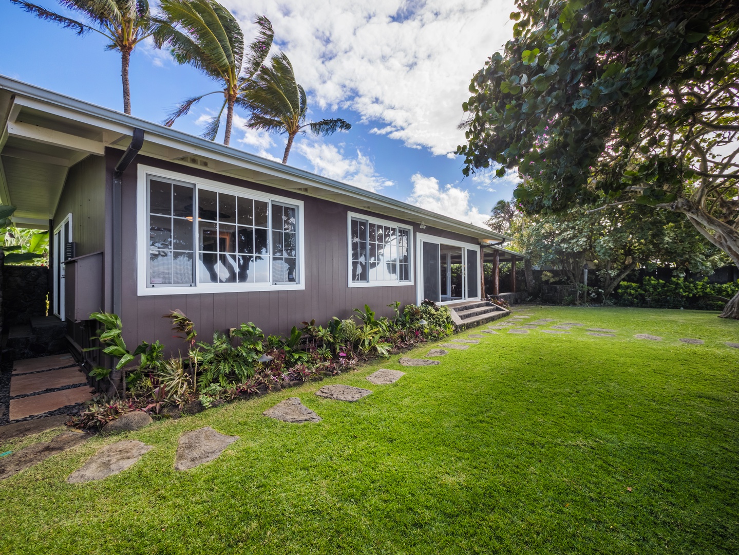 Haleiwa Vacation Rentals, Sunset Point Hawaiian Beachfront** - Lush green yards for a fun family time.