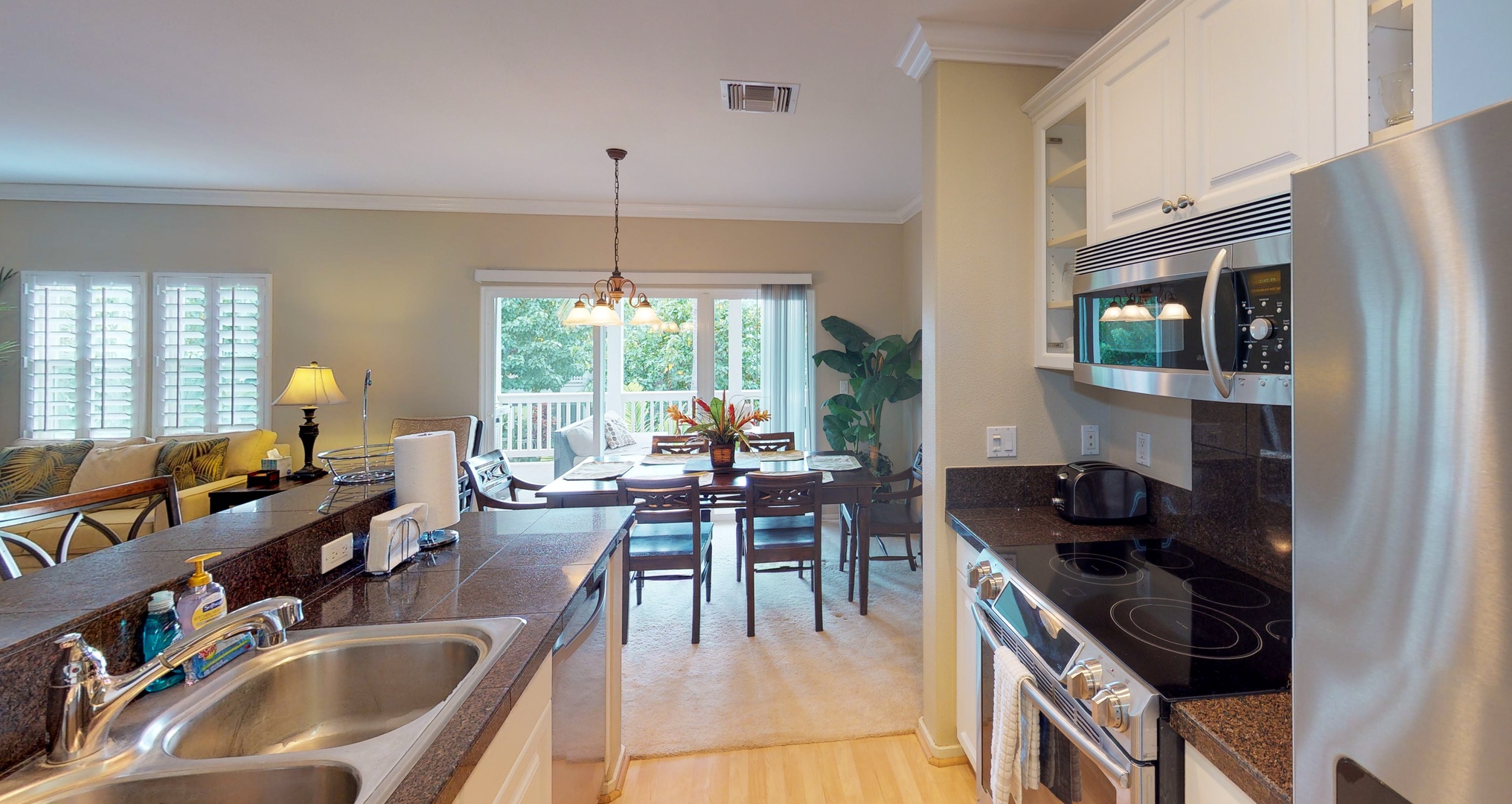 Kapolei Vacation Rentals, Coconut Plantation 1194-3 - A view from the kitchen towards the dining area and outdoors.