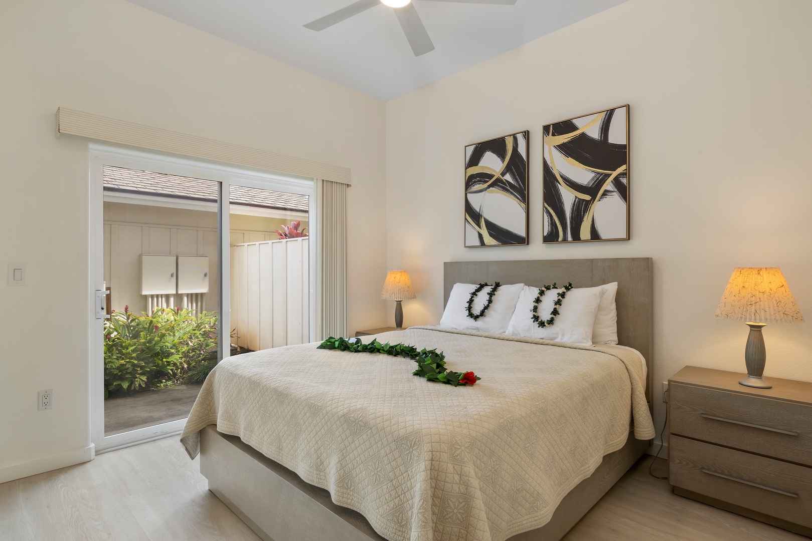 Kapolei Vacation Rentals, Coconut Plantation 1078-3 - The primary guest bedroom with access to private lanai, a TV and comfort for a restful slumber.