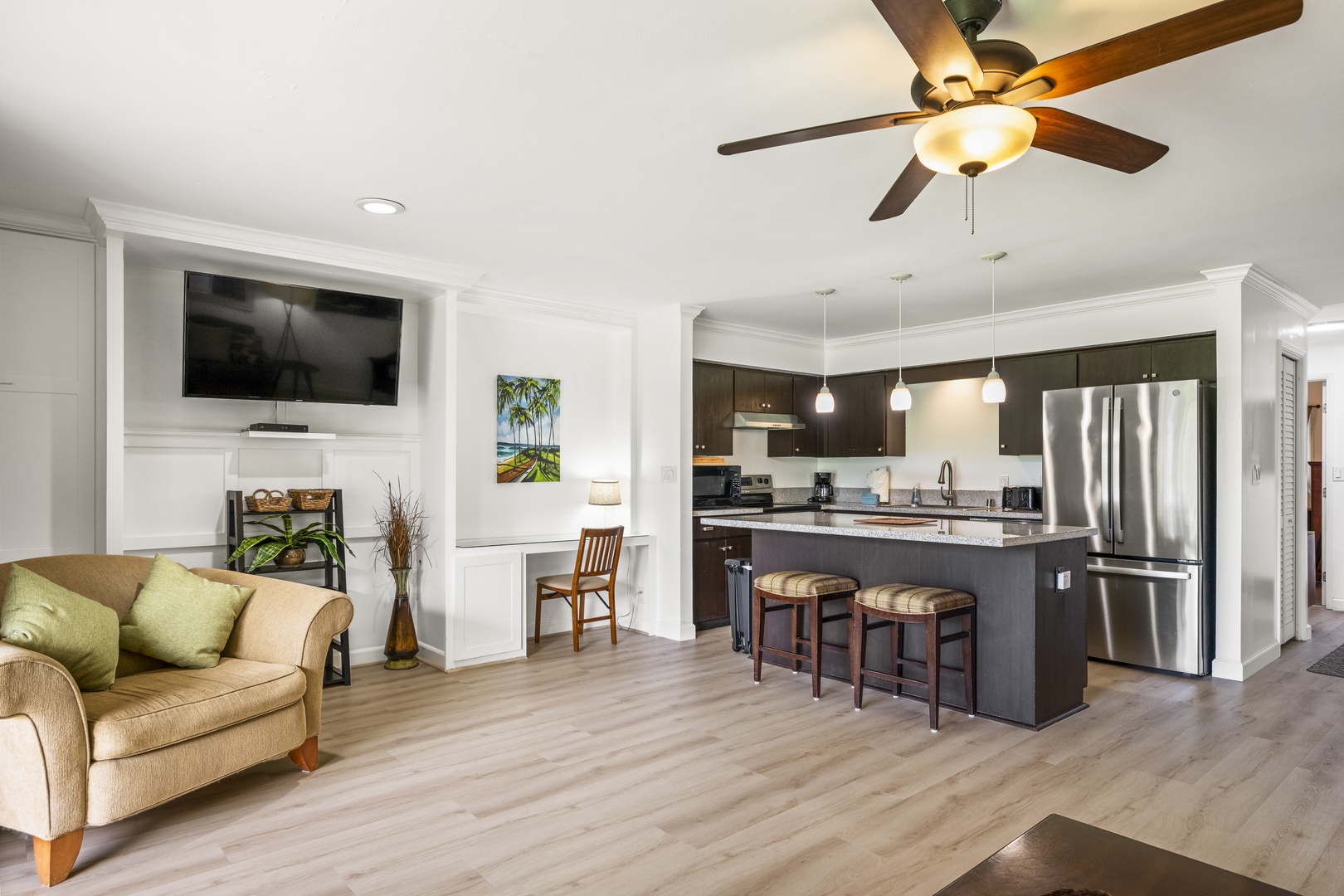 Kihei Vacation Rentals, Koa Resort 1B - Movie nights land easily, the sectional facing the wall-mounted TV with the kitchen just behind.