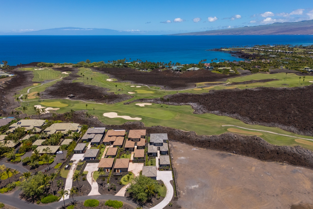 Waimea Vacation Rentals, 5BD Mauna Lani Lux Golf Estate (4) at One Ocean - This aerial photograph showcases a beautifully integrated residential community adjacent to a golf course.