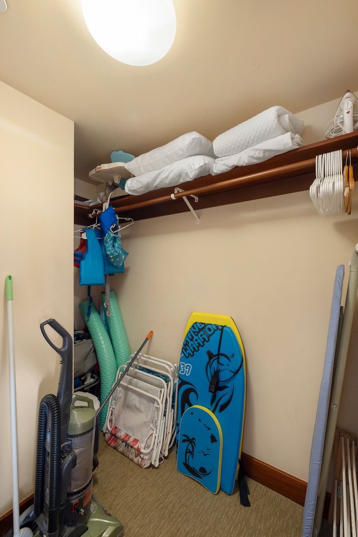 Kapolei Vacation Rentals, Ko Olina Beach Villas B210 - Closet with extra linens, vacuum, and bodyboards.