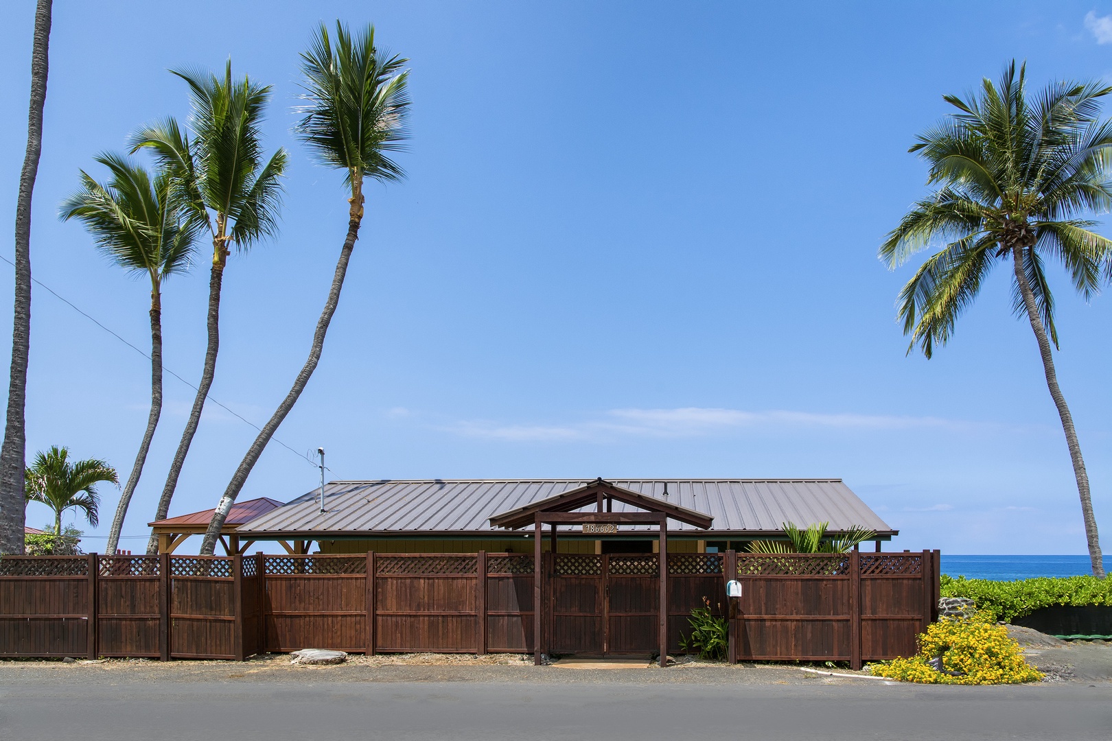 Kailua Kona Vacation Rentals, The Cottage - Across the street looking towards the house which is fenced all the way around.