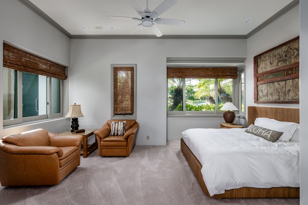 Kamuela Vacation Rentals, Canoe House & Beach Walker at Champion Ridge - Bright and spacious guest bedroom with queen-sized bed, cozy seating, large windows, and a peaceful view