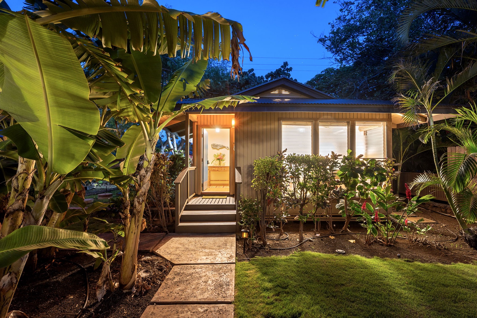 Kamuela Vacation Rentals, Island Time Retreat - Warm light spills from the entry, tropical plants lining the walk-in.