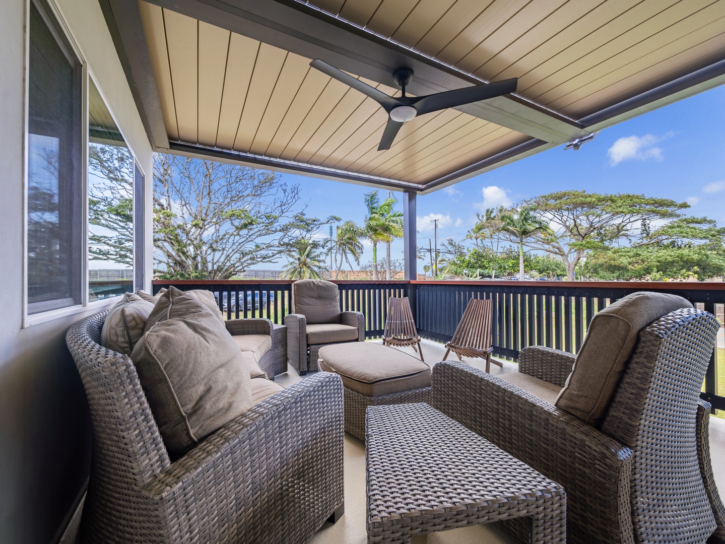 Haleiwa Vacation Rentals, Sunset Beach Island Retreat - The covered outdoor lanai offers a cozy seating area, perfect for enjoying a morning coffee or evening cocktail while taking in the tranquil surroundings and refreshing breeze