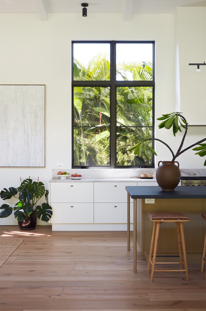 Honolulu Vacation Rentals, Diamond Head Hillside Estate** - Framed by oversized windows and tropical greenery, the kitchen brings the beauty of the outdoors into everyday moments.