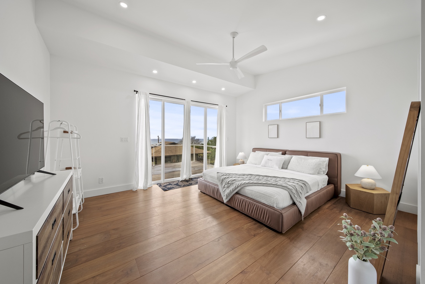 Haleiwa Vacation Rentals, Villa Bianca - Spacious minimalist primary suite upstairs with access to a private lanai.