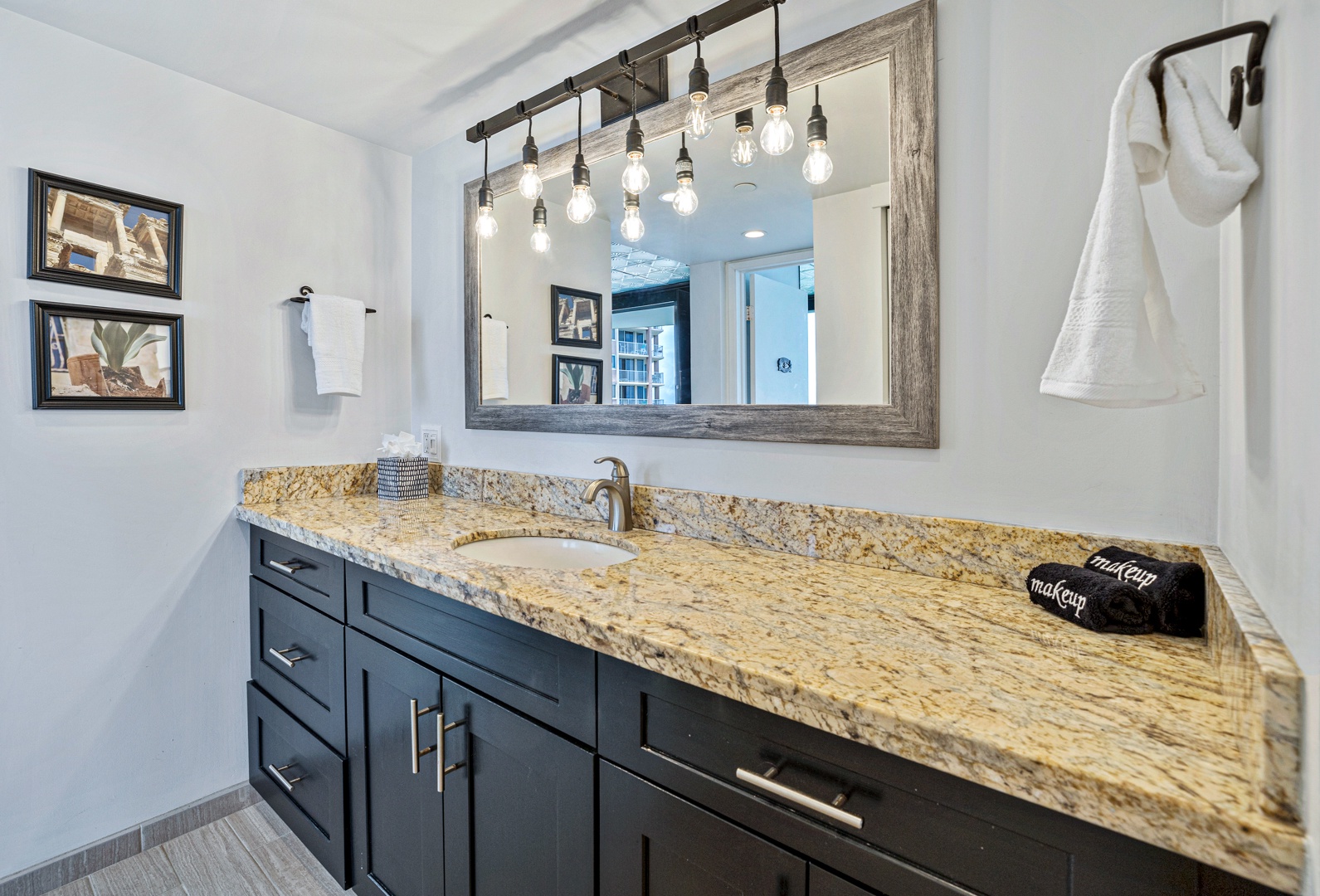 Lahaina Vacation Rentals, Valley Isle 804 - The spacious vanity in this bathroom boasts a granite countertop and ample storage, paired with modern lighting to create a relaxing ambiance